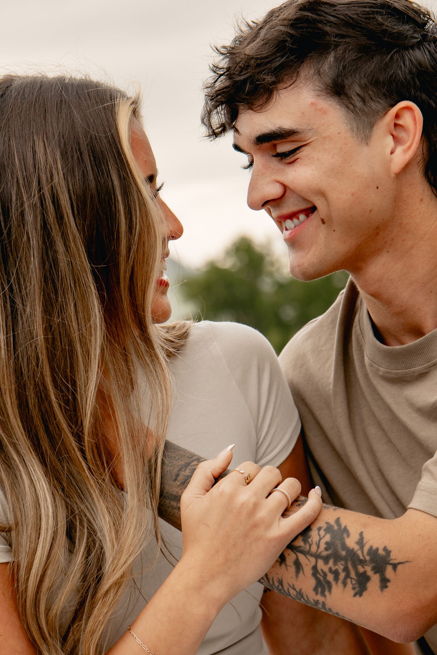 A series of intimate close-up shots showing a couple in a tender outdoor moment highlighting hands and expressions.