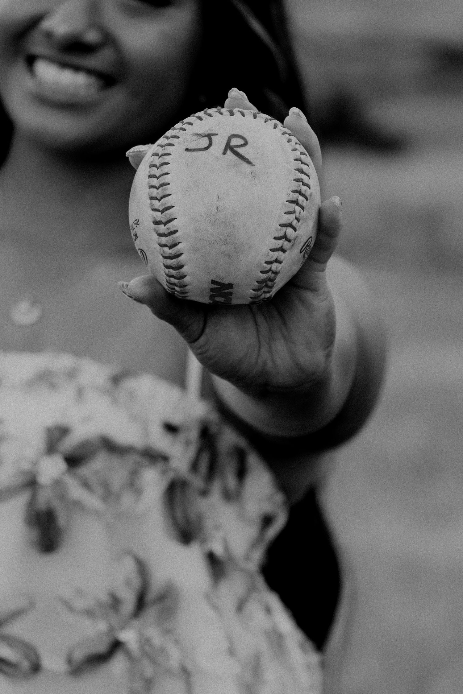 A sequence of black and white images showing a close-up view of baseballs held in a player's hand.