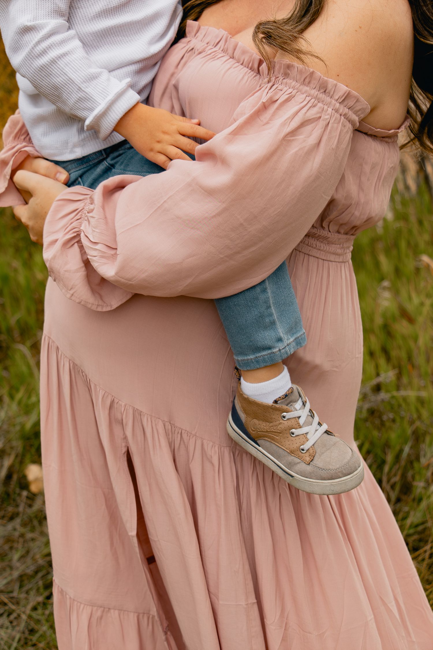 Close-up detail shots of a pink dress and gray sneakers showing casual feminine style in an outdoor setting.