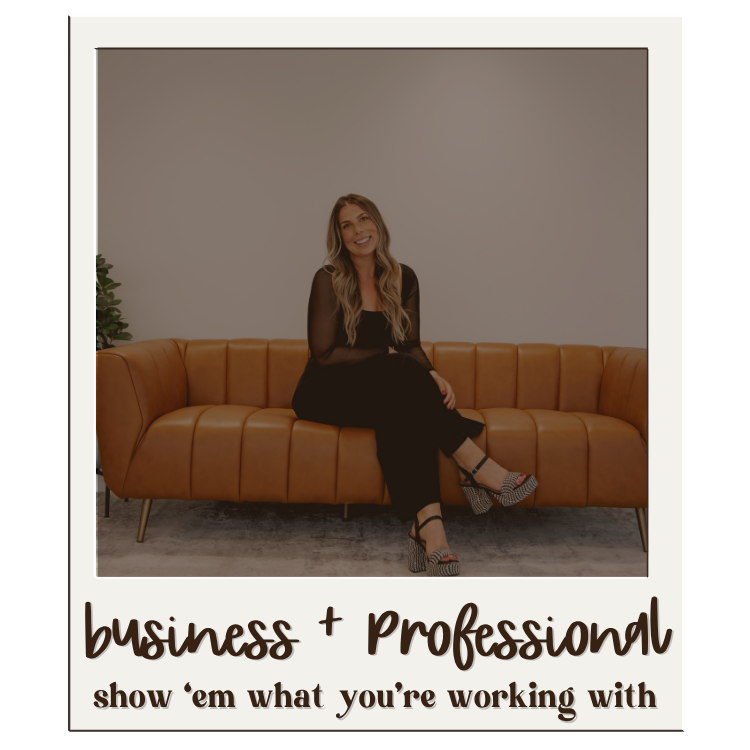 Professional woman in black outfit sits casually on a tan leather couch in a modern interior setting.