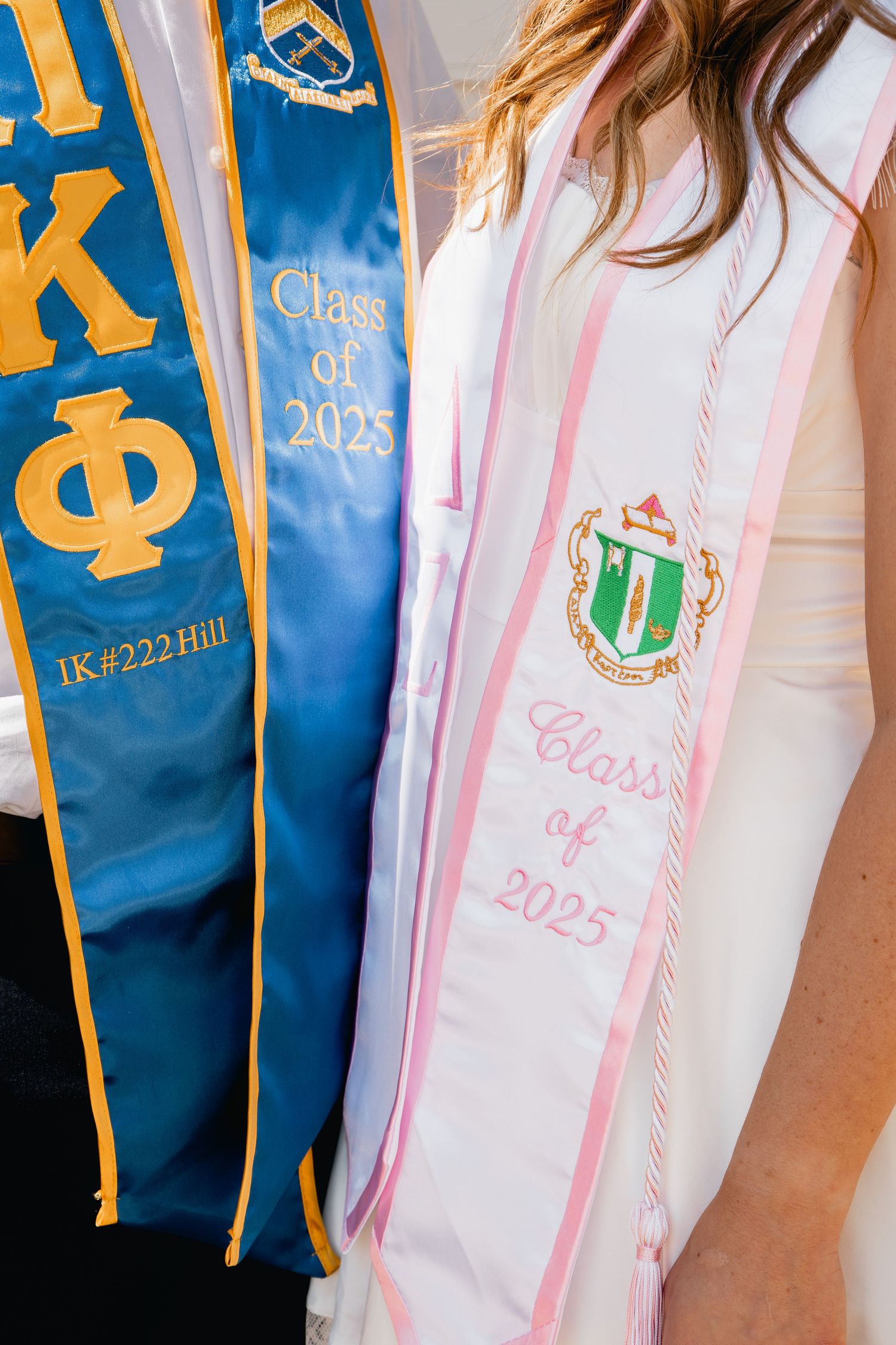 Graduation stoles showing Pi Kappa Phi and sorority membership for Class of 2023 in blue gold pink and white colors.