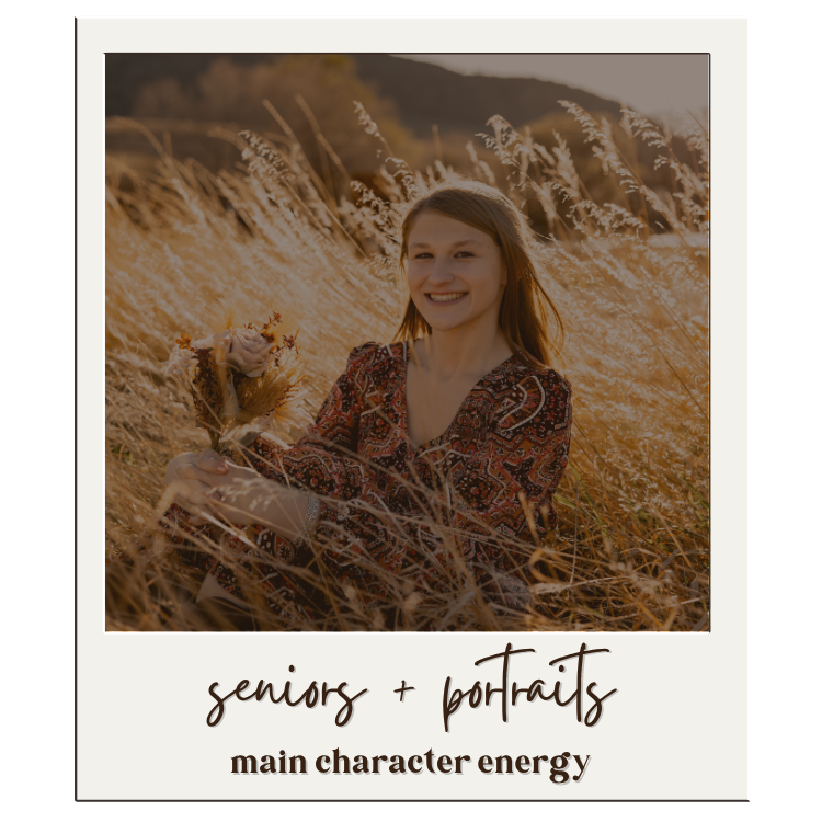 Young woman smiling in golden field holding flowers, senior portrait with warm sunset light and natural outdoor setting.