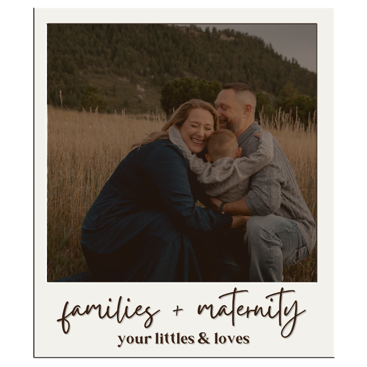 Family and maternity photo of parents hugging young child in golden field with mountain backdrop.