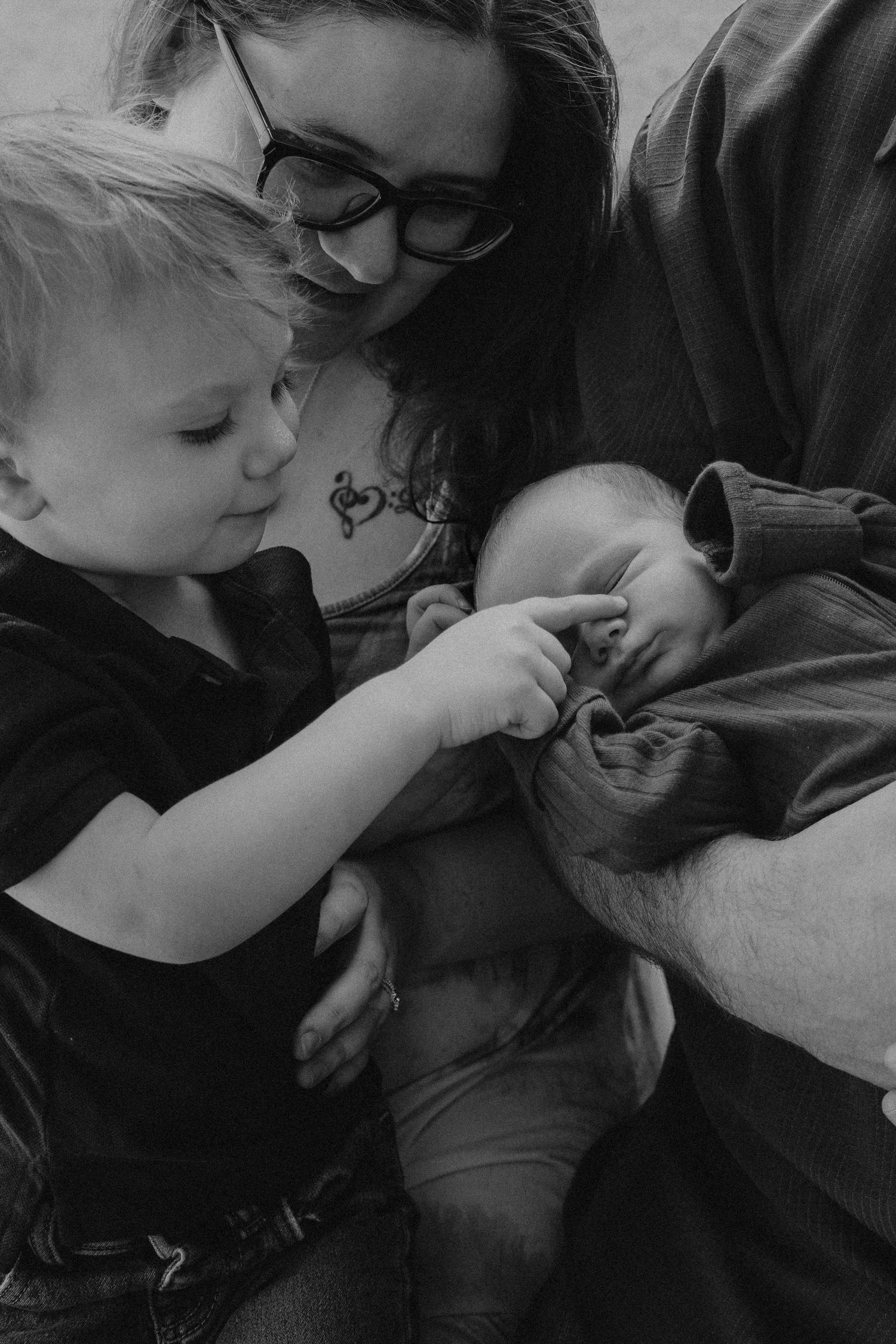 A touching moment captured in black and white showing two people embracing while resting on a couch.