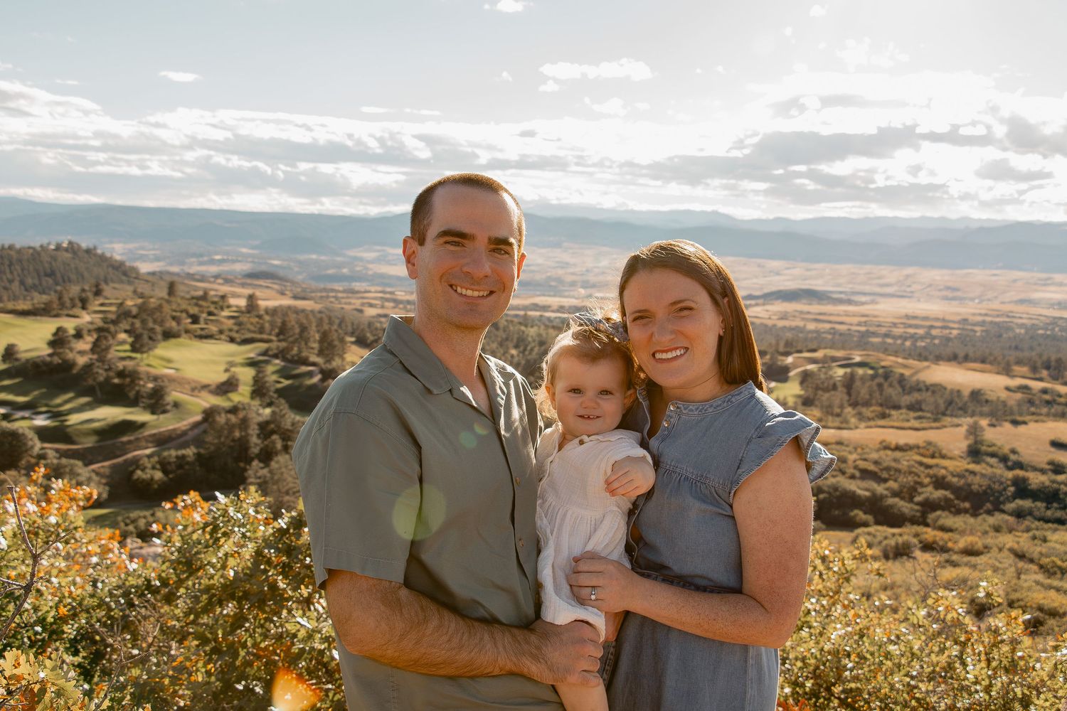 Family enjoying scenic mountain views together on a sunny afternoon hike through rugged terrain.