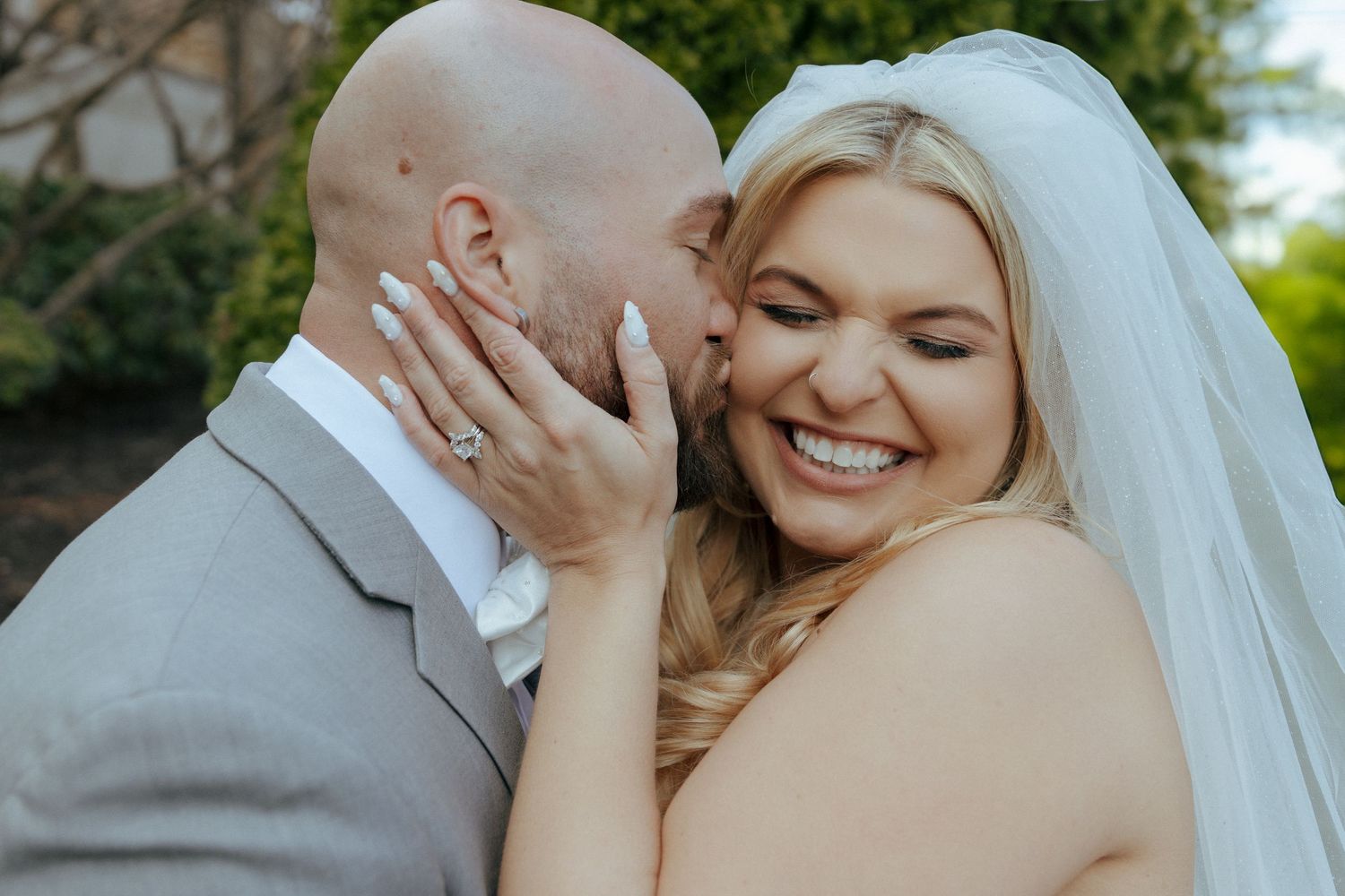 Close-up romantic moments captured during an outdoor wedding celebration.