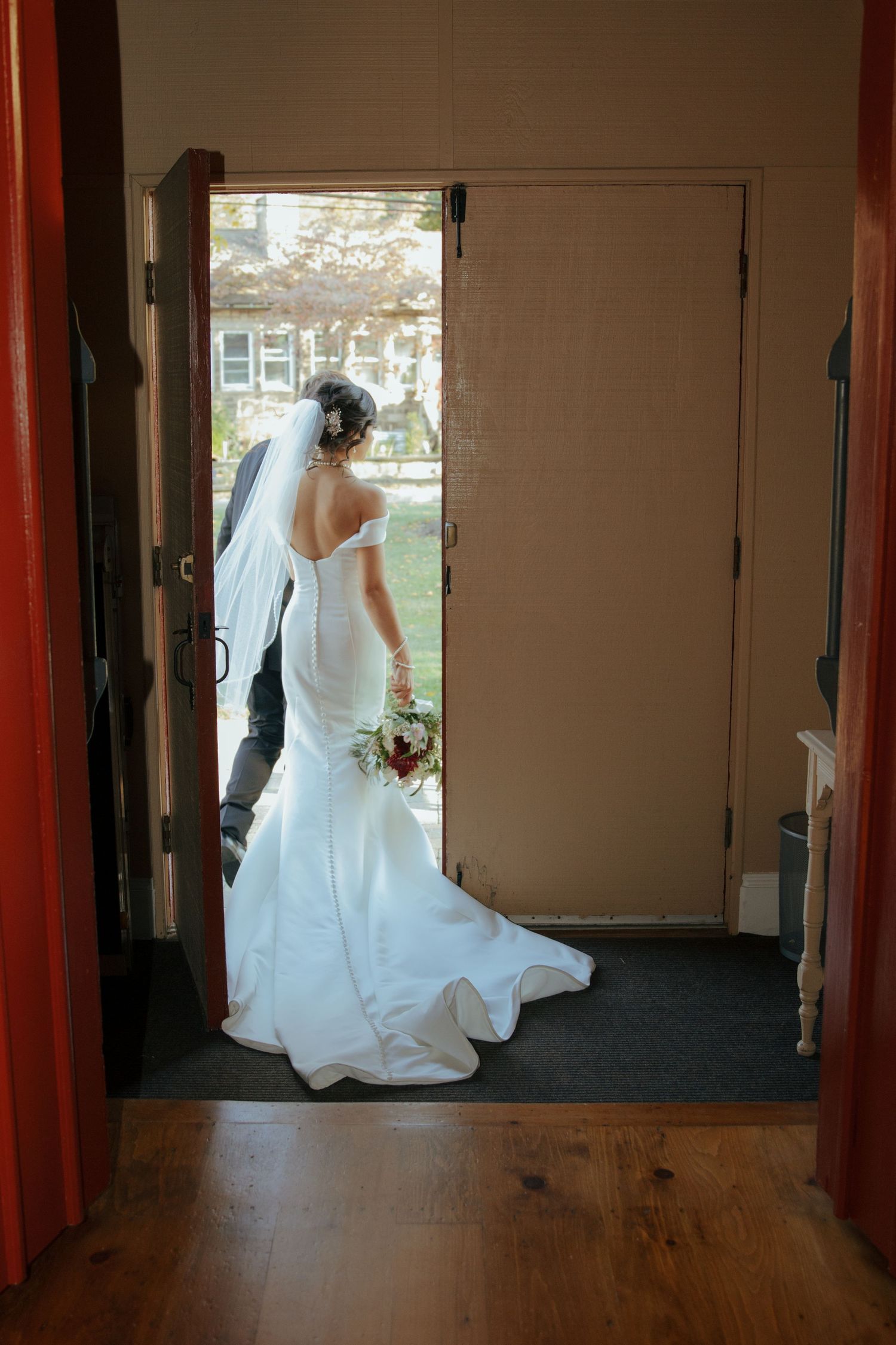A flowing white wedding dress captured in motion through a series of doorway frames.