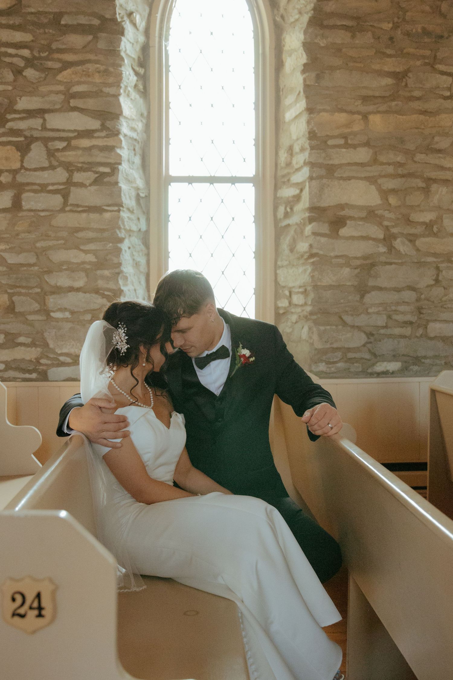 A romantic sequence of wedding photos showing a couple sharing intimate moments in vintage wooden church pews.