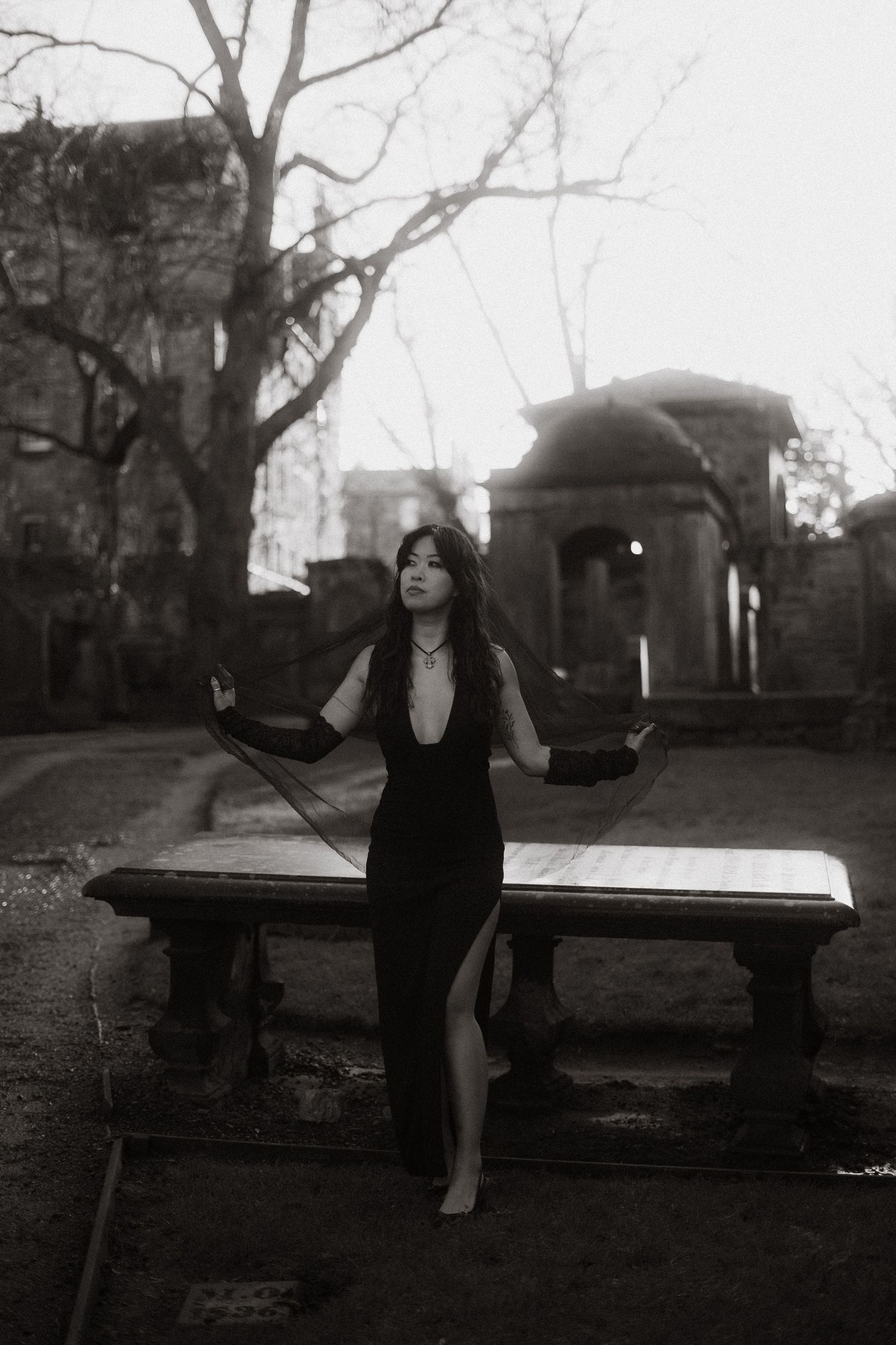 A black and white photo sequence shows a person in dark clothing sitting and posing on a stone wall in a moody outdoor setting.