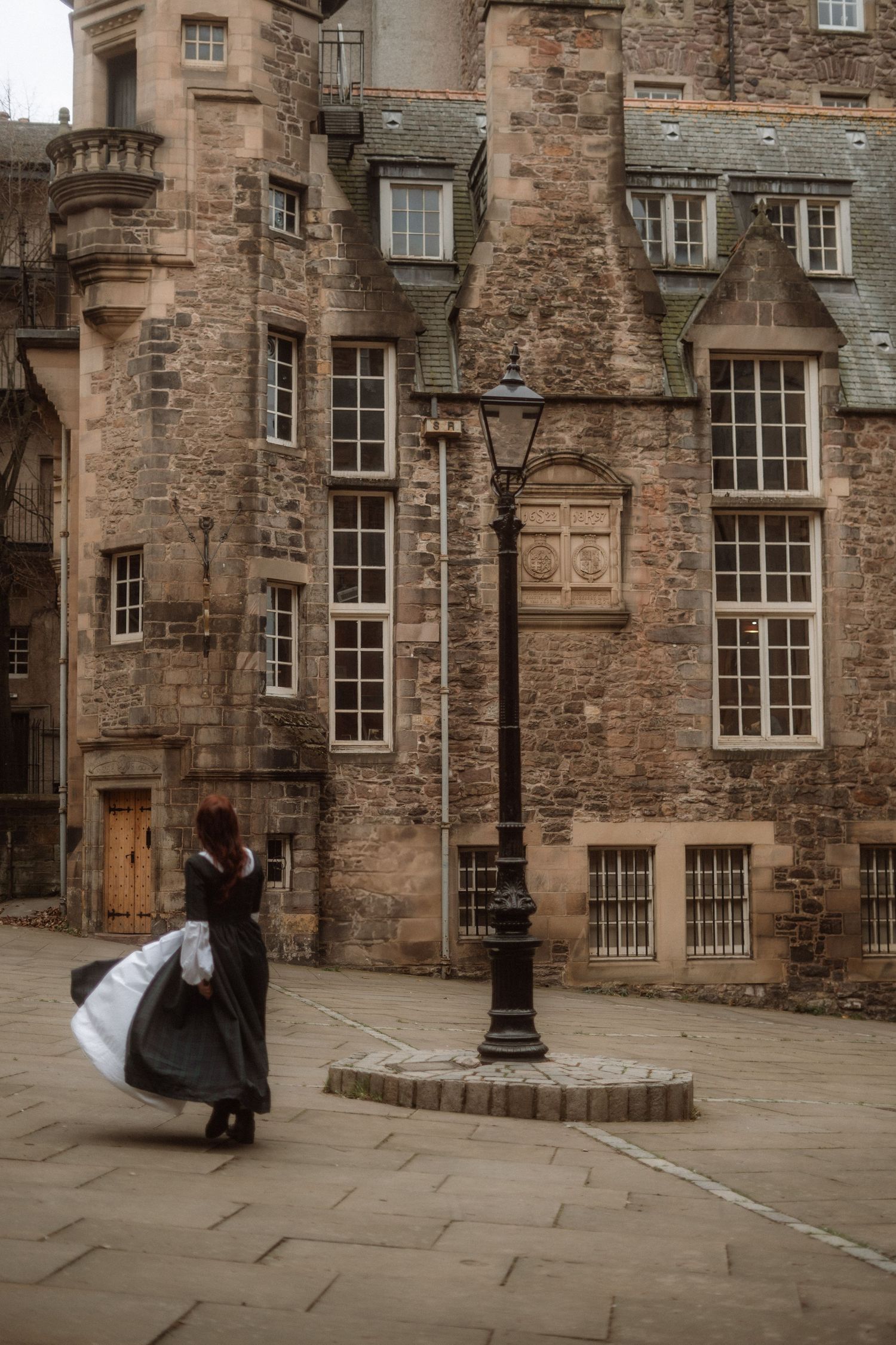 A sequence of four images showing figures in dark clothing against historic stone buildings in Edinburgh's Royal Mile.