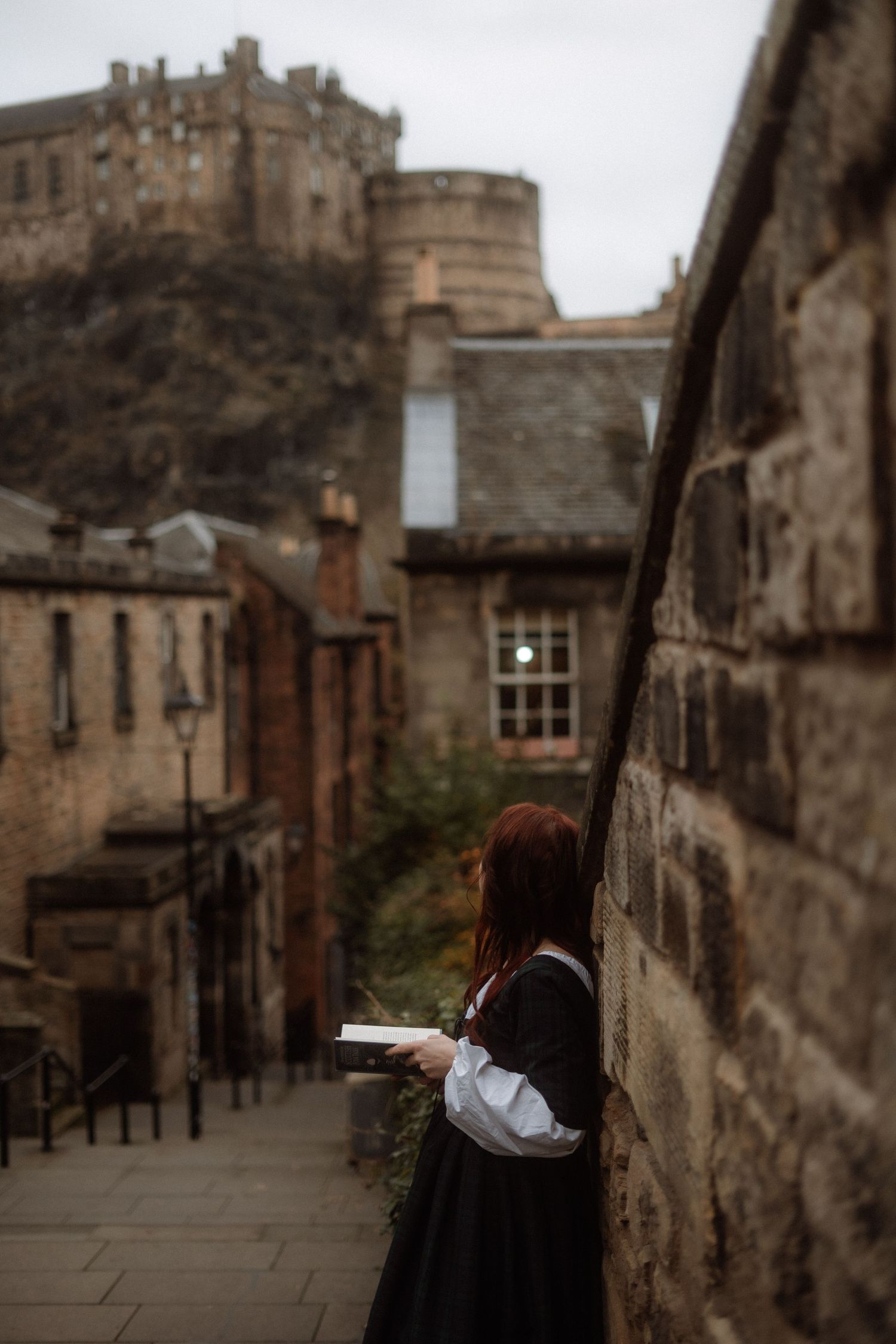 A series of moody street scenes showing narrow cobblestone alleys and historic stone buildings in Edinburgh's Old Town.