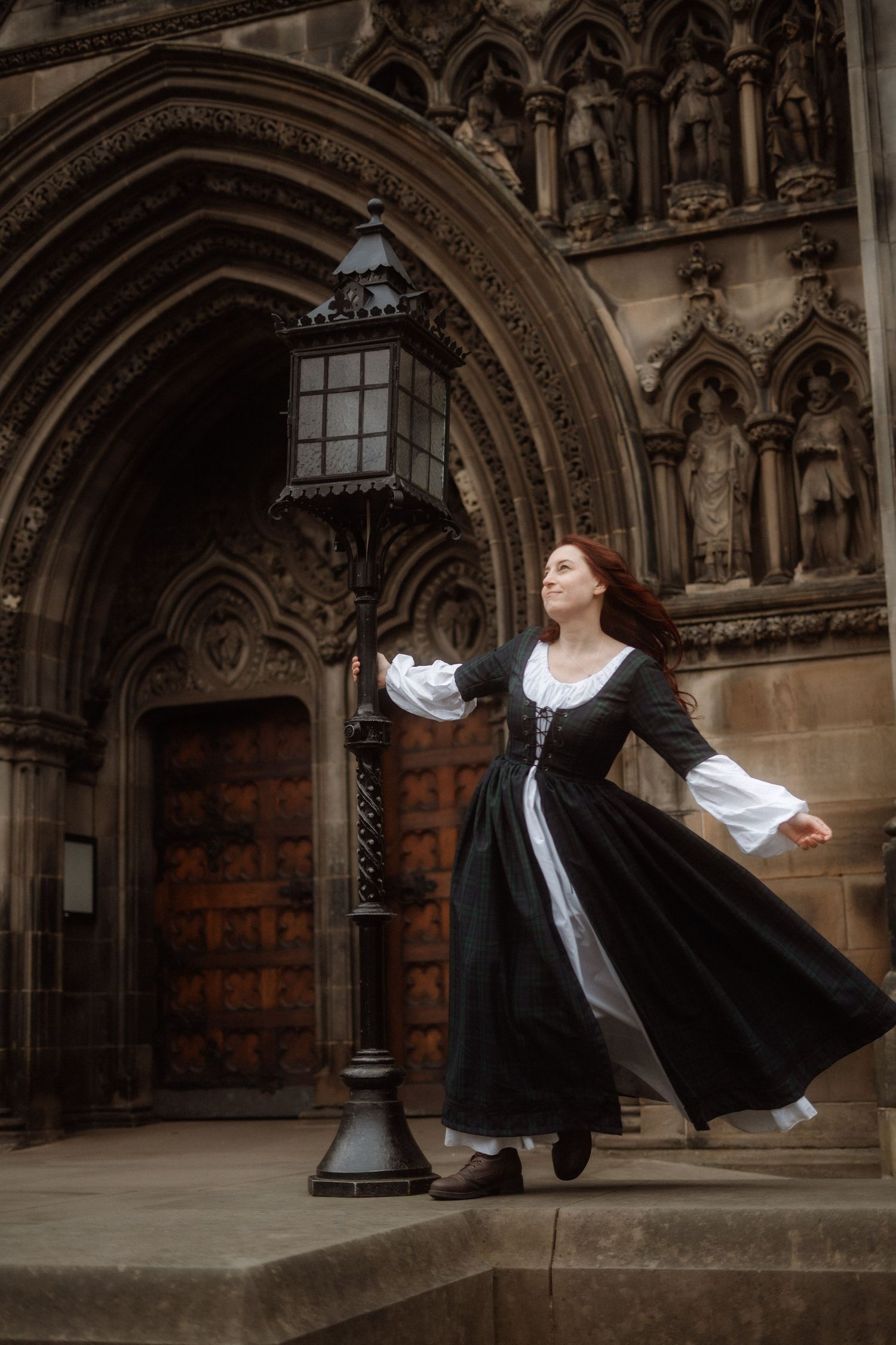 A series of artistic photos showing a person in medieval costume dancing and twirling in front of a Gothic archway.