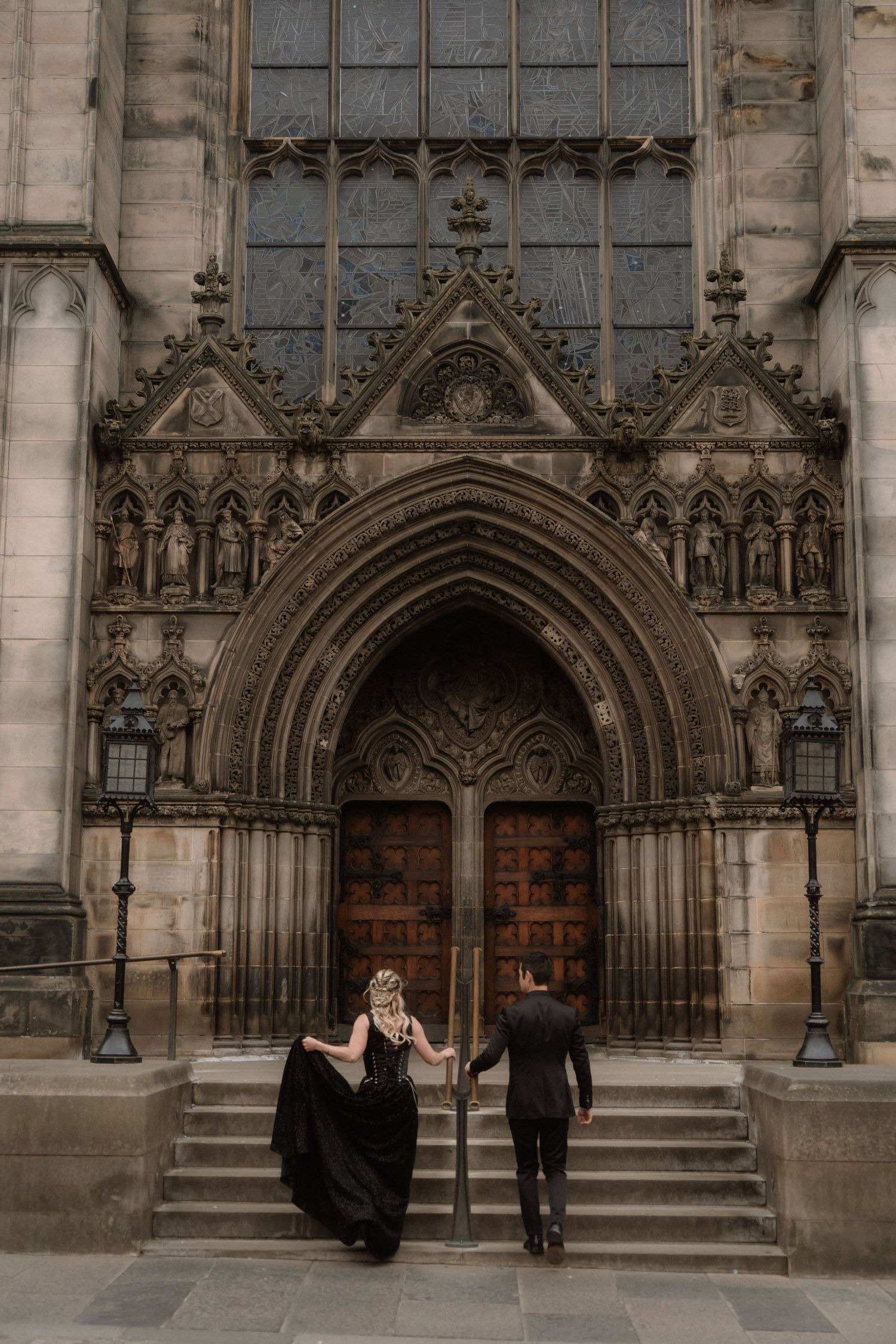 A dance performance unfolds in front of an ornate Gothic cathedral entrance.