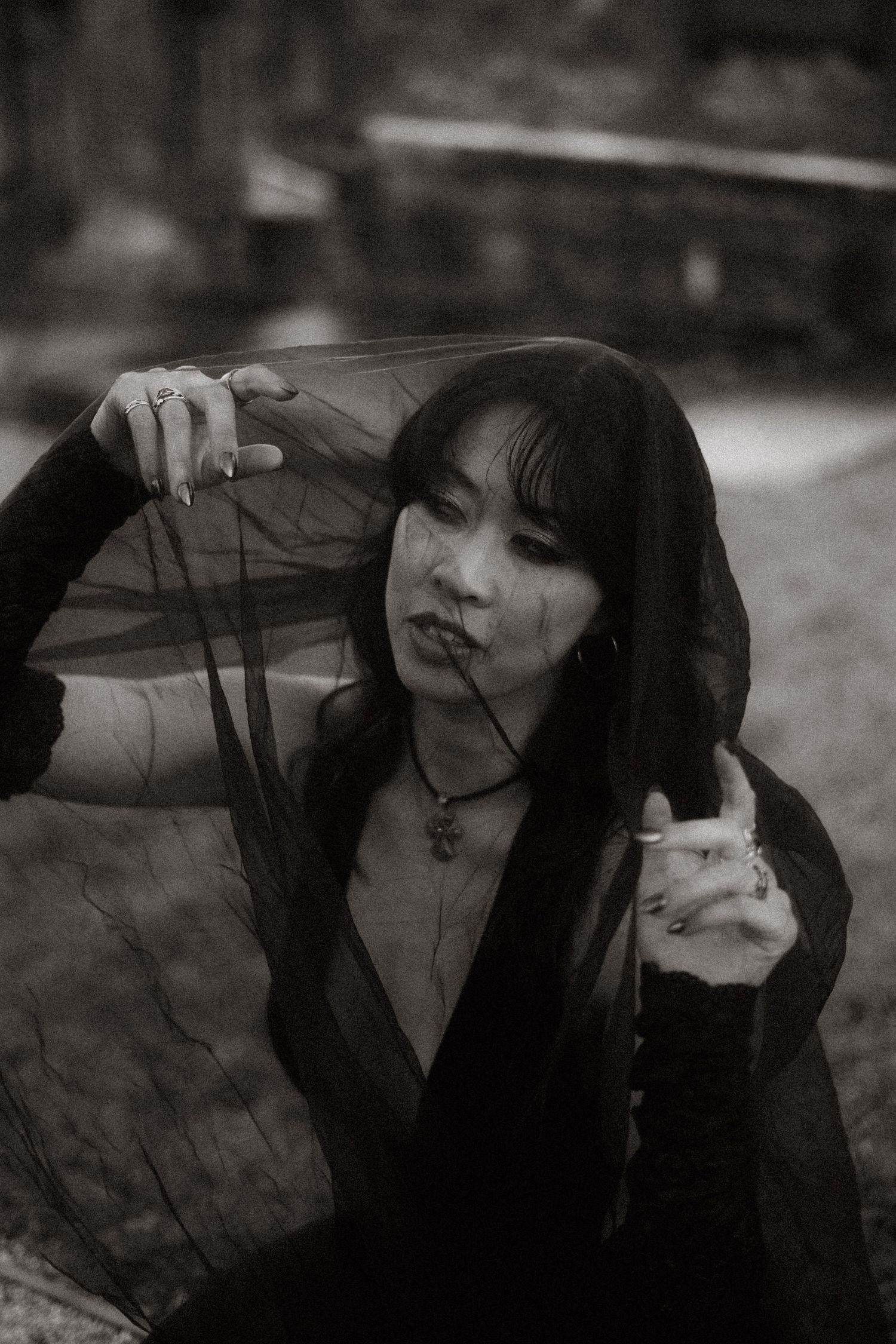 A black and white photo series showing a figure in dark clothing against a moody background with dramatic poses.