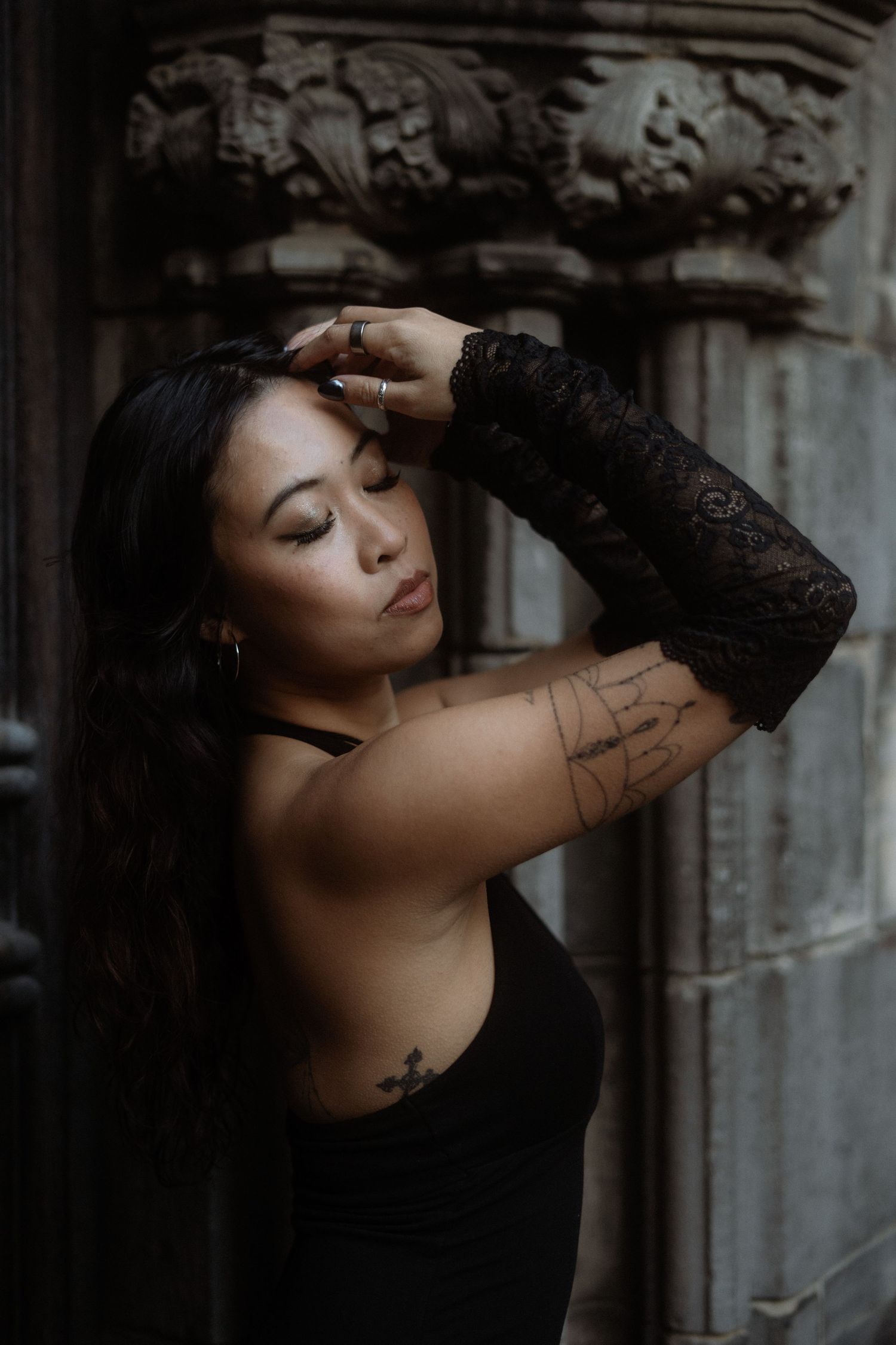 Artistic portrait series showing graceful poses against a textured concrete wall in moody dramatic lighting.