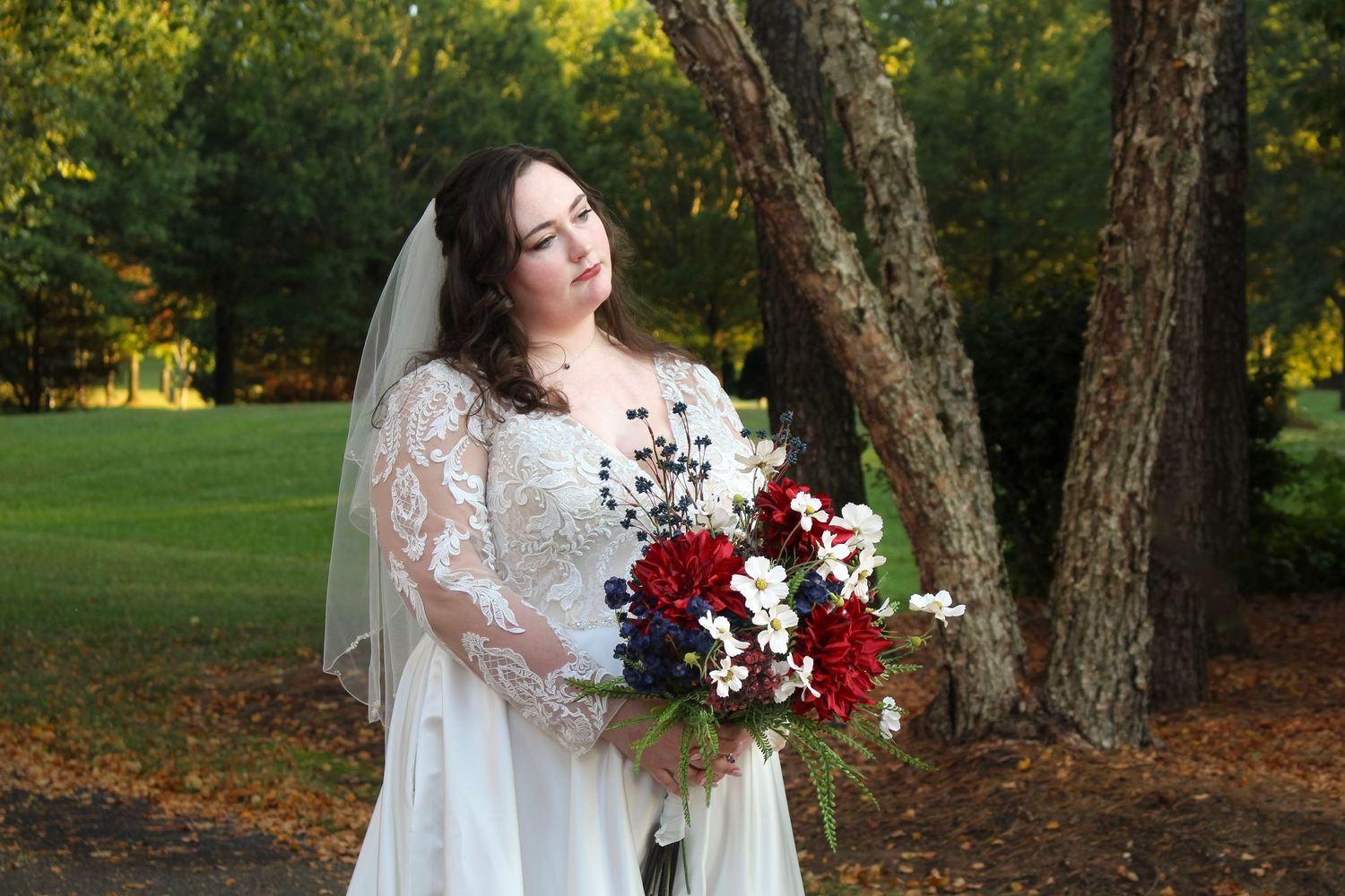 This is another picture for a wedding, the bride looks gorgeous as she watches the wedding party goof off in the background.