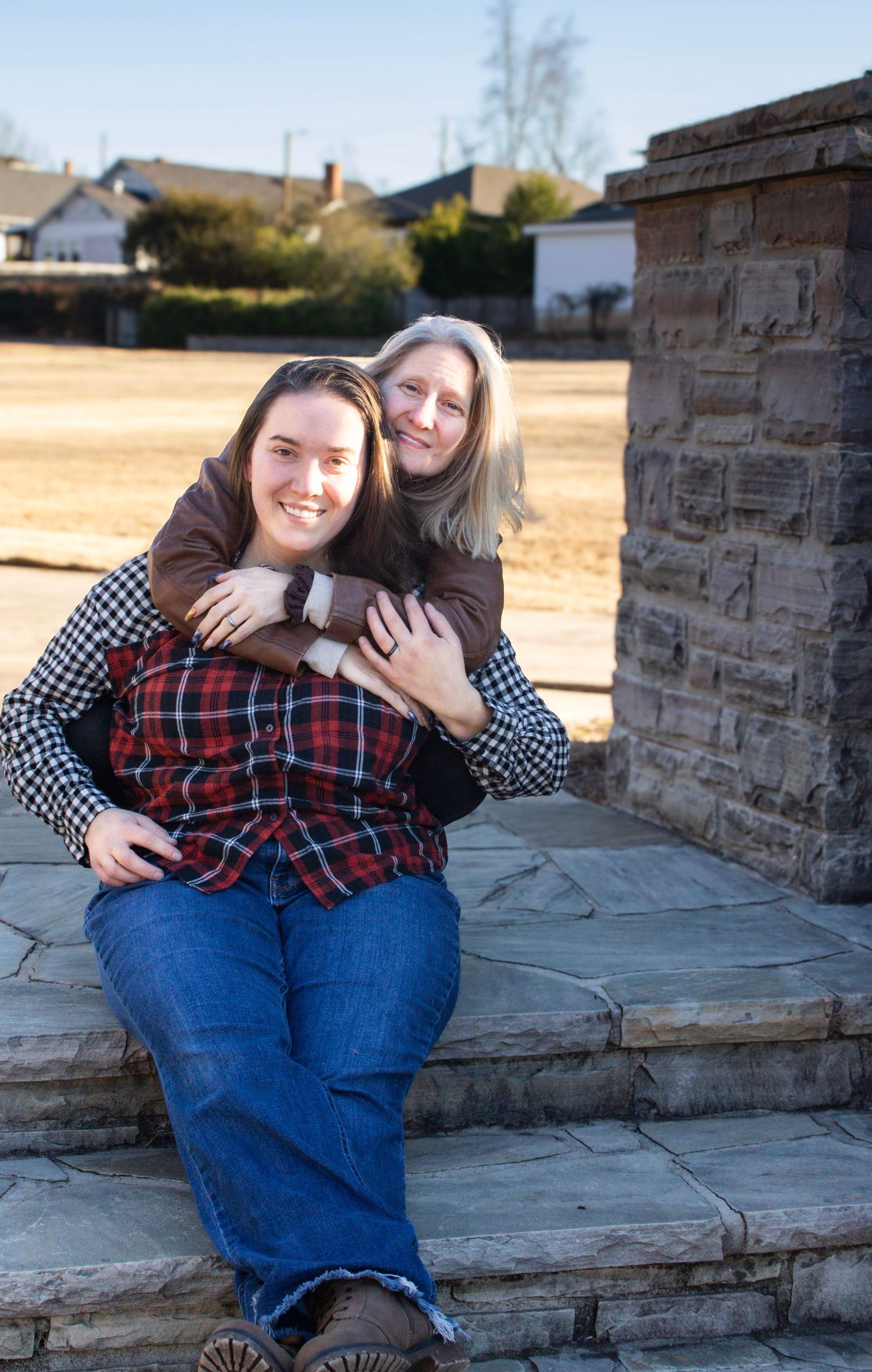 This is a photo of the mom and her daughter, hugging each other.