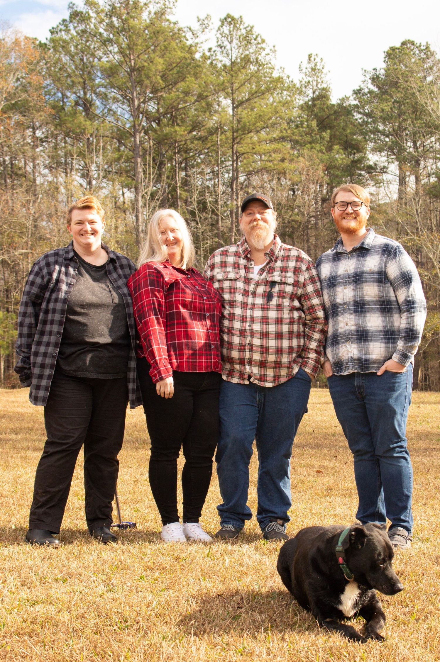This is a photo of the mom and dad and their two sons and the family dog.