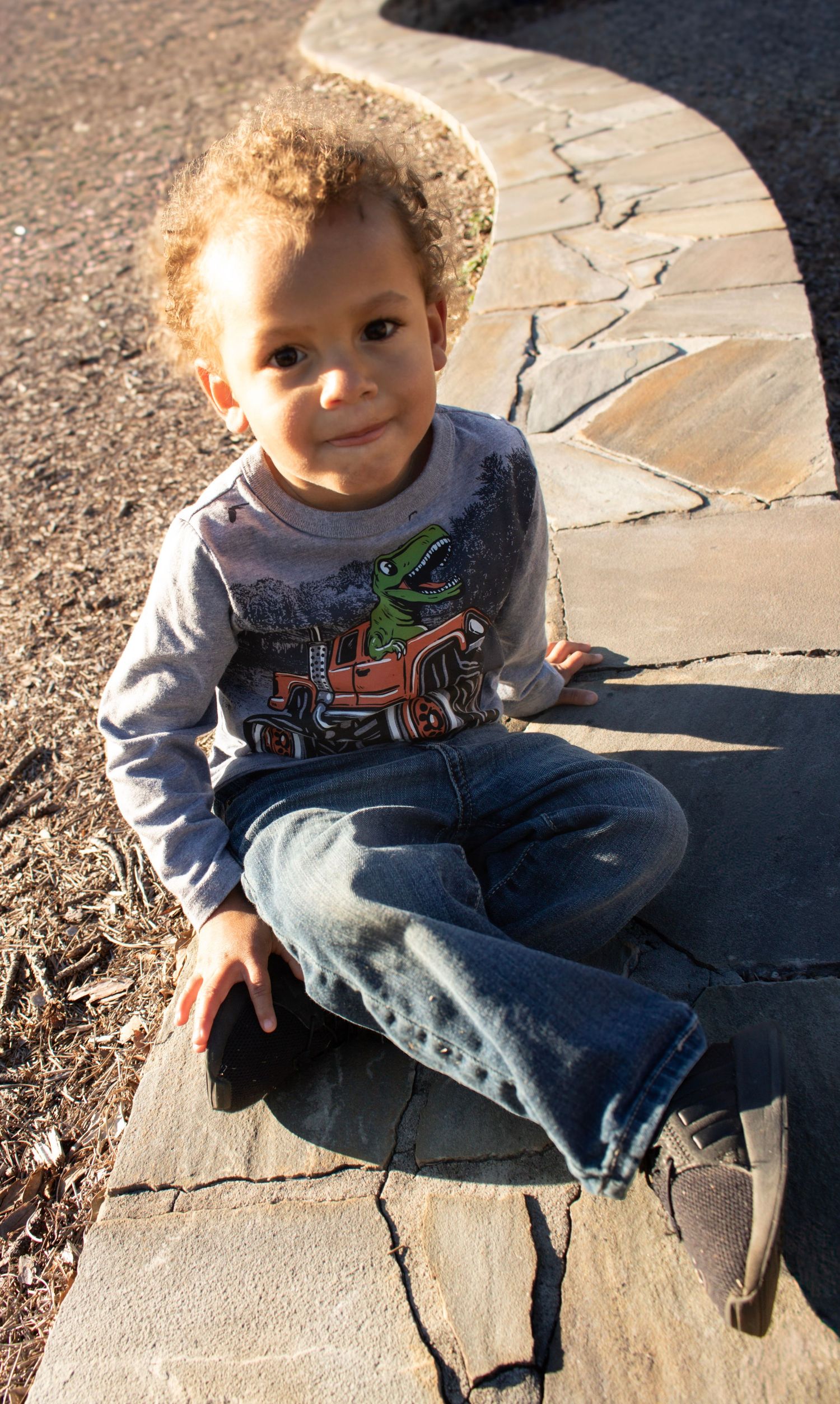 This is a cute photo of the kid smiling sweetly at the camera.