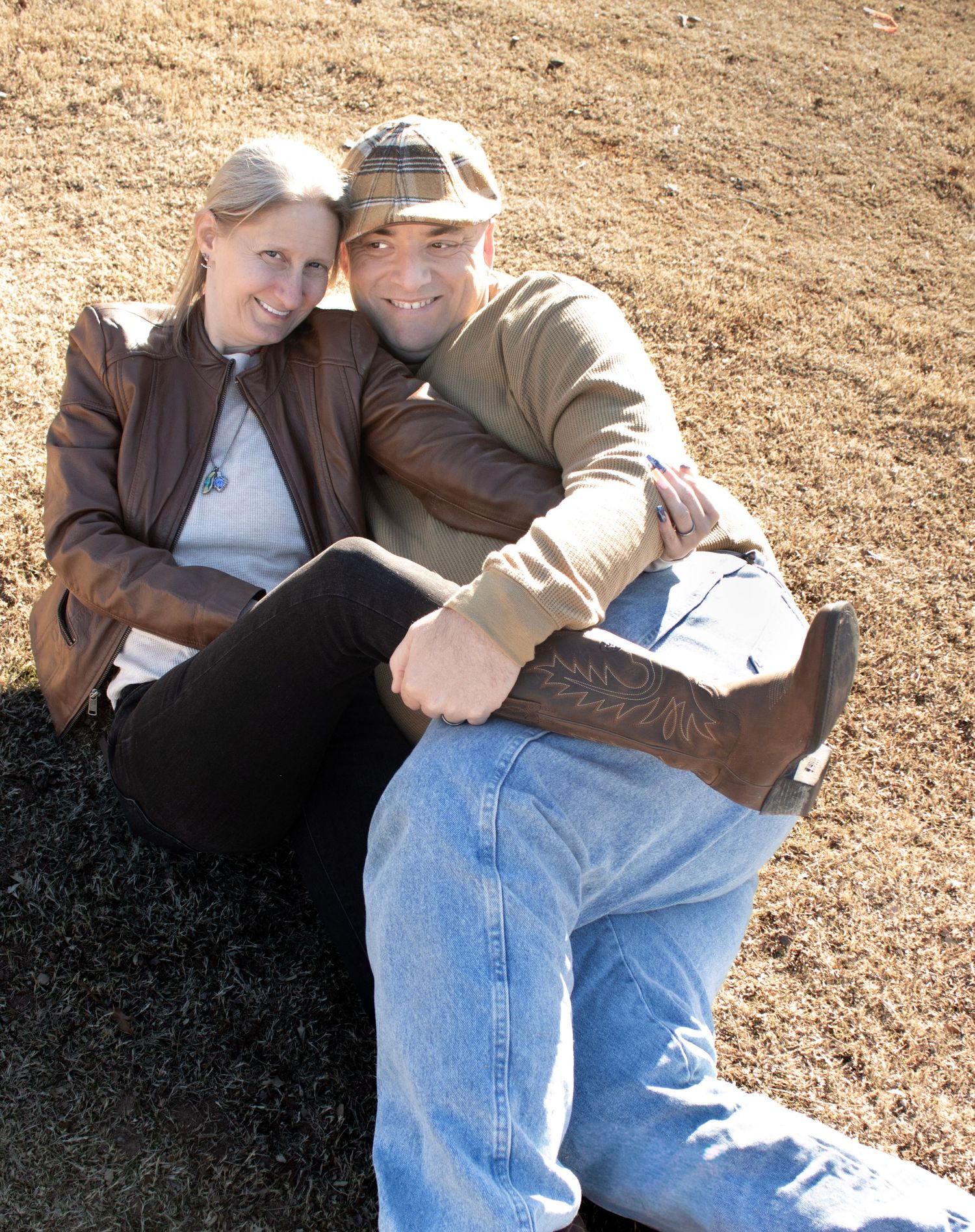 This is a cute photo of the grandparents cuddling in the grass.