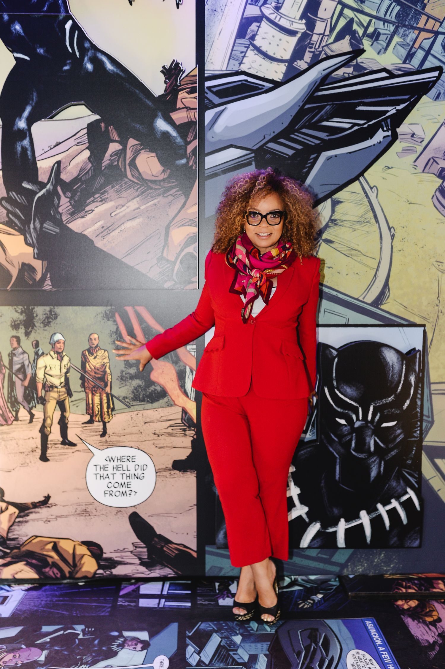 A series of photos showing someone in a red blazer posing with Black Panther movie posters and promotional materials.