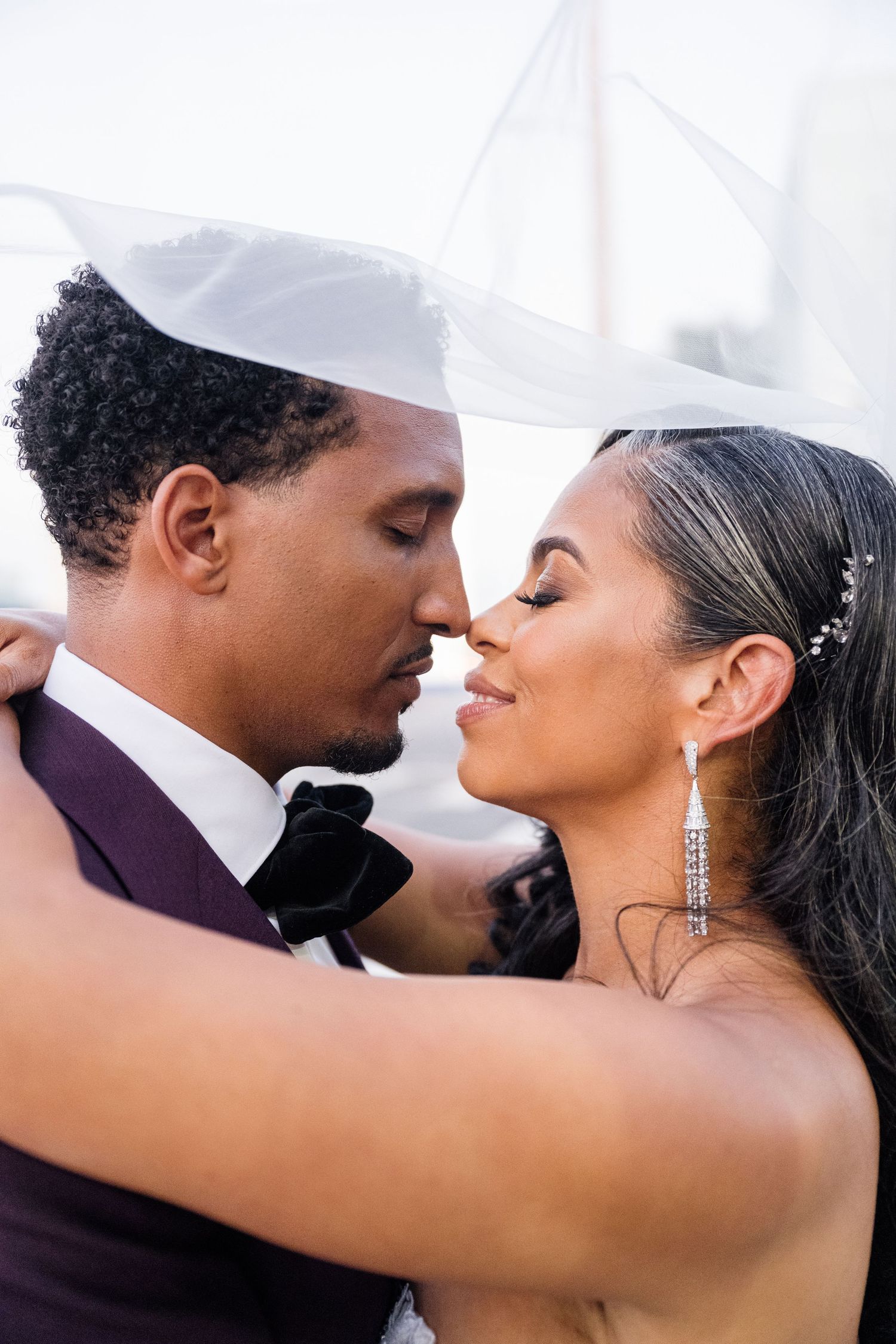 Romantic wedding couple sharing intimate kisses in a series of elegant portraits.