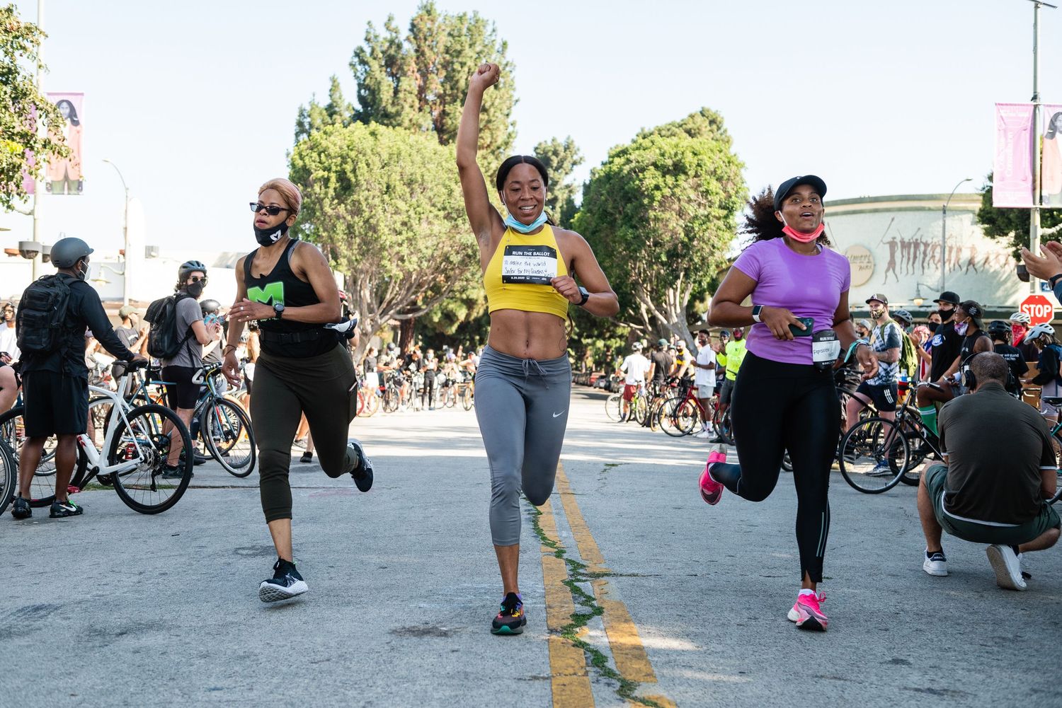 Group of people exercising and moving together outdoors on a sunny day.