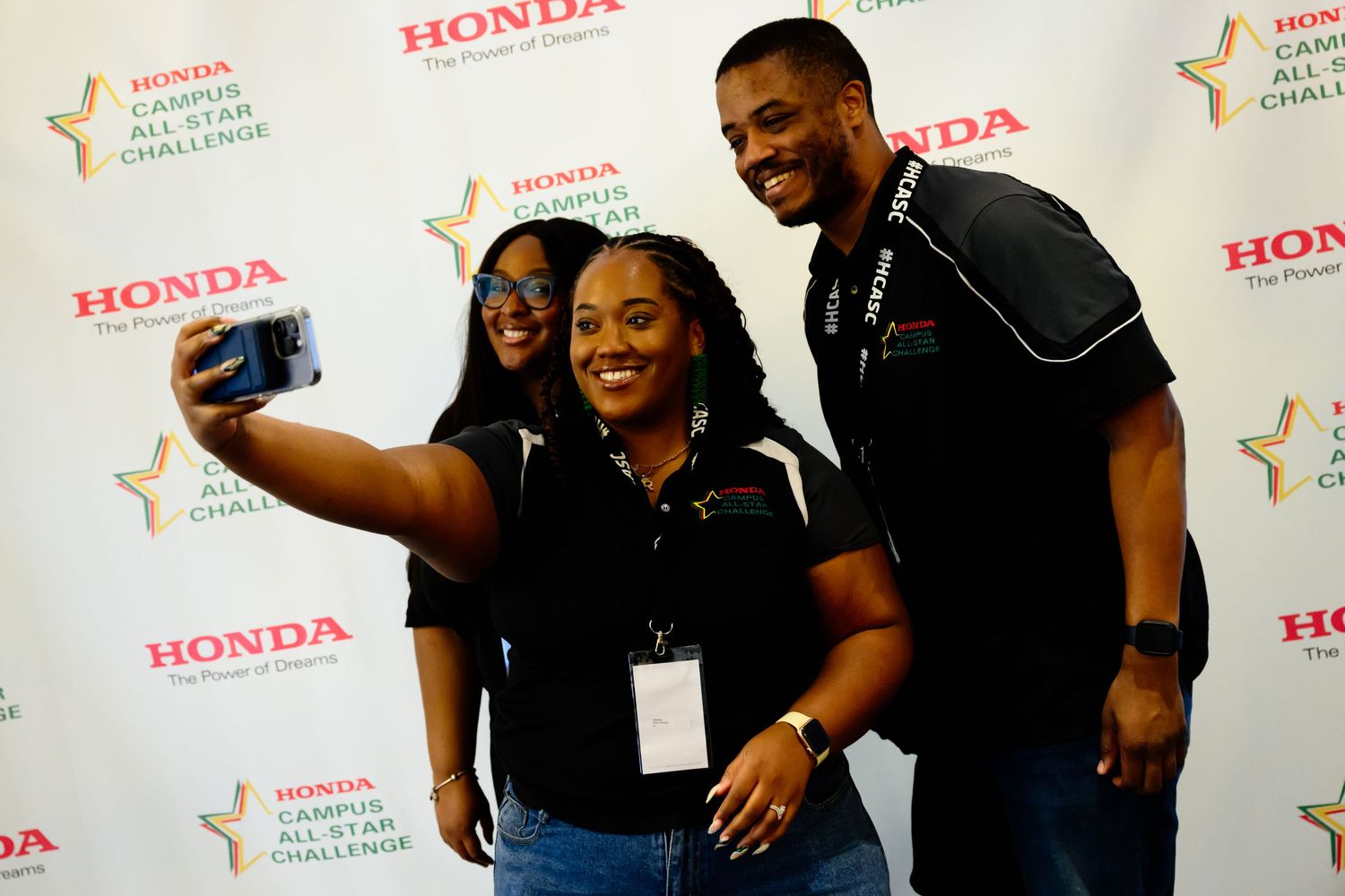 Candid moments captured at Honda branded event backdrop.