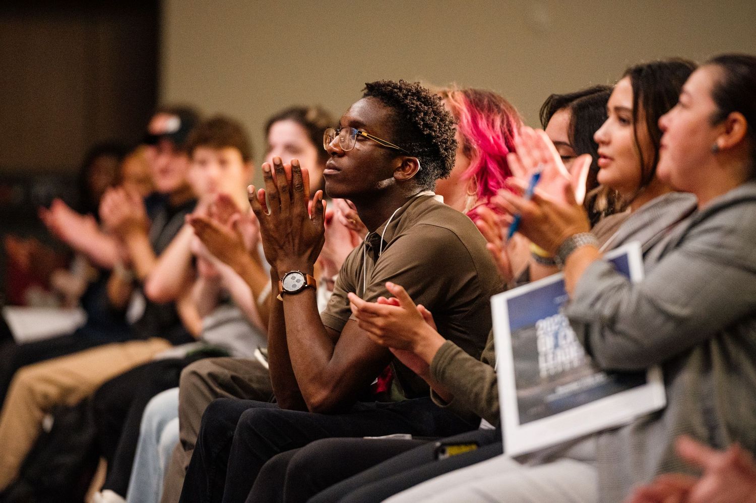 Engaged audience members reacting emotionally during a presentation or performance.