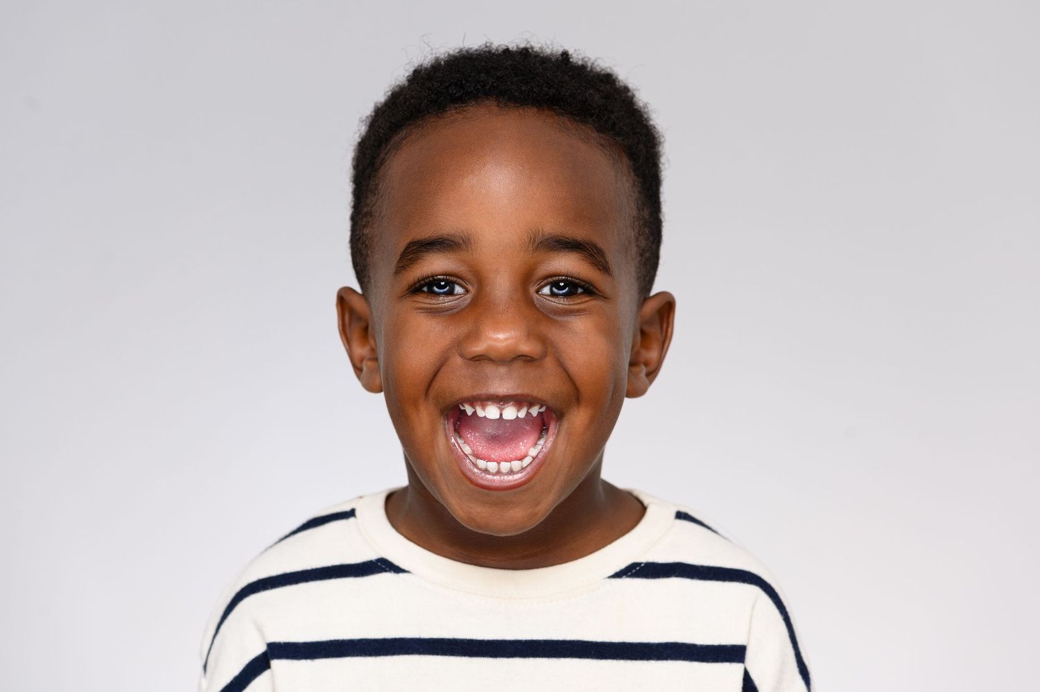 Professional headshot series showing joyful expressions and bright smiles against a white background.