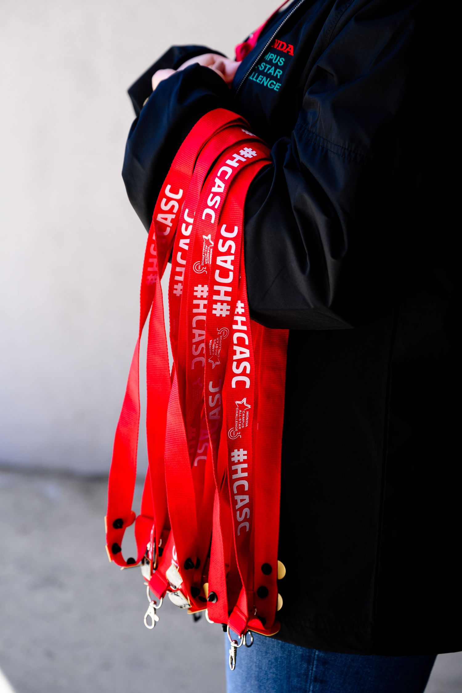 Close-up shots of red lanyards hanging against black background.