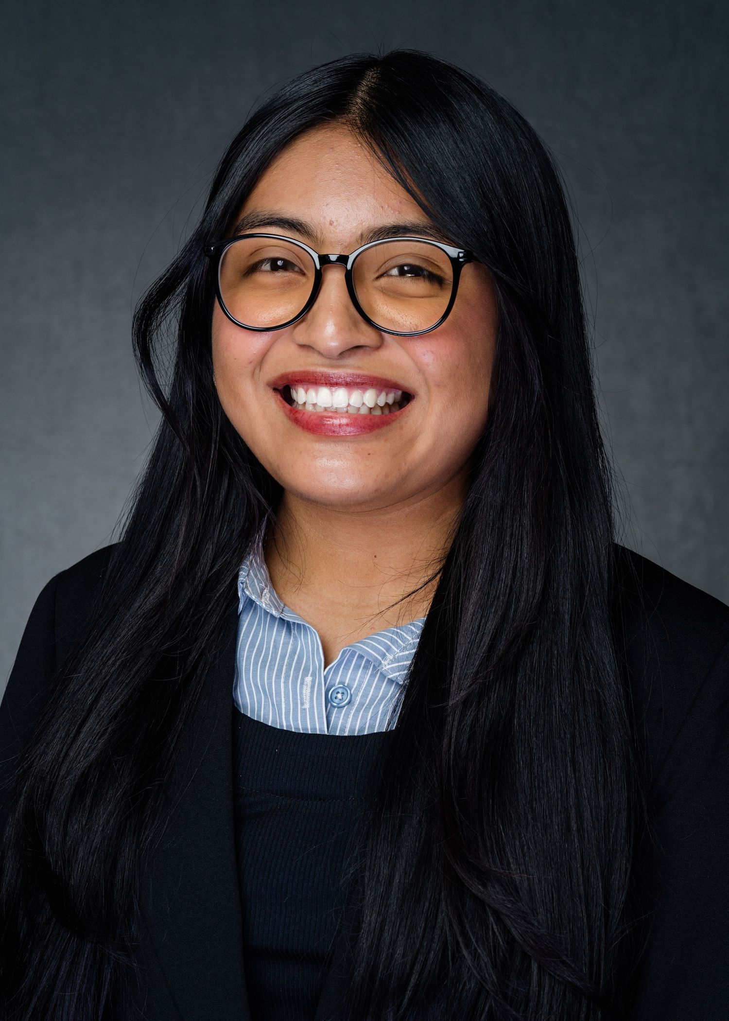 Series of headshots showing someone in glasses and black sweater against dark background.