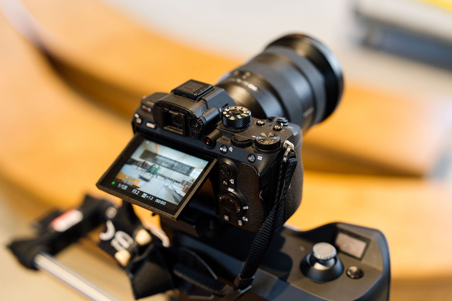 Close-up view of a camera lens aperture mechanism showing intricate metal blades in a circular pattern.
