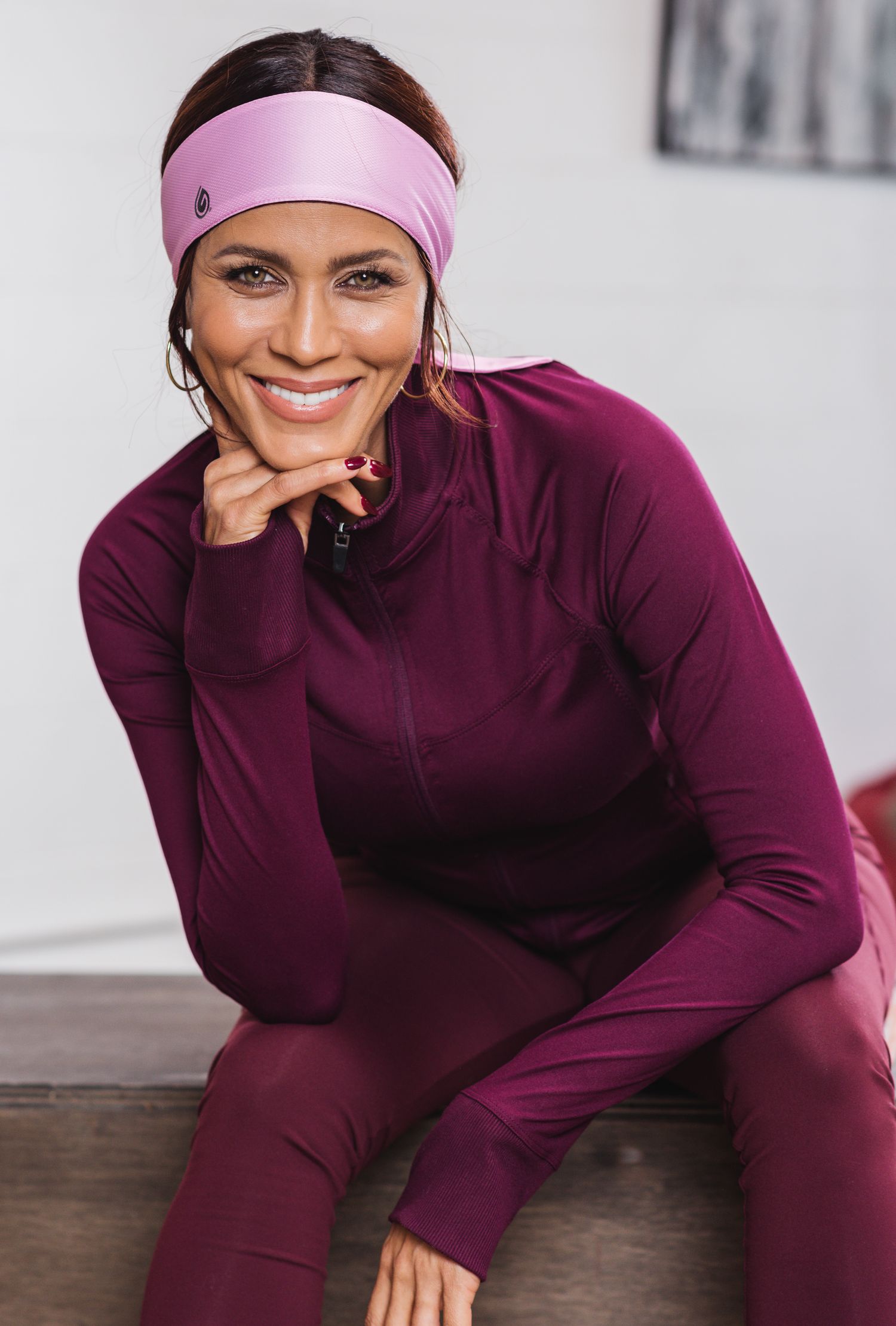 Burgundy athletic wear showcased in studio setting.