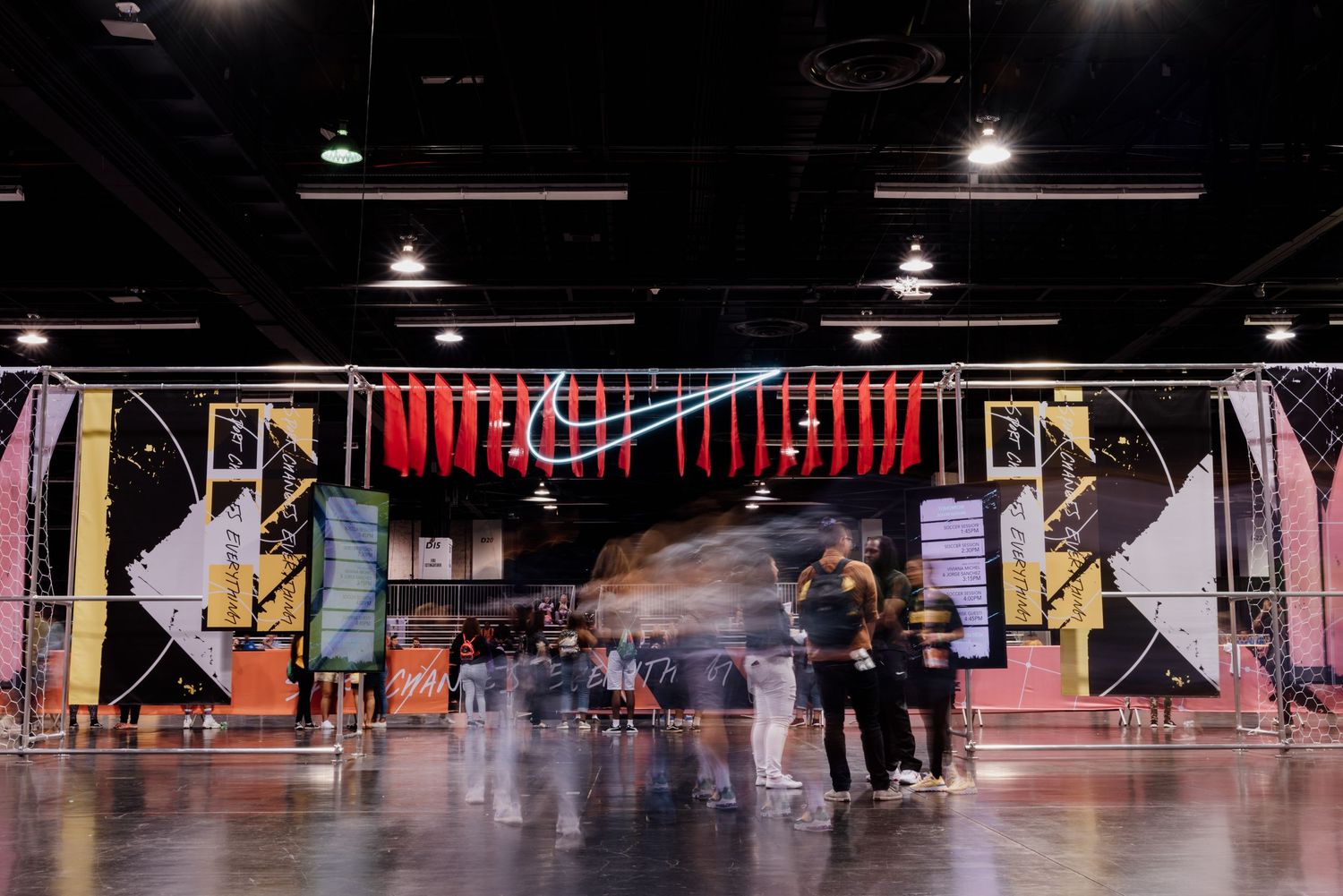 Modern Nike retail space interior with geometric design elements and people shopping.