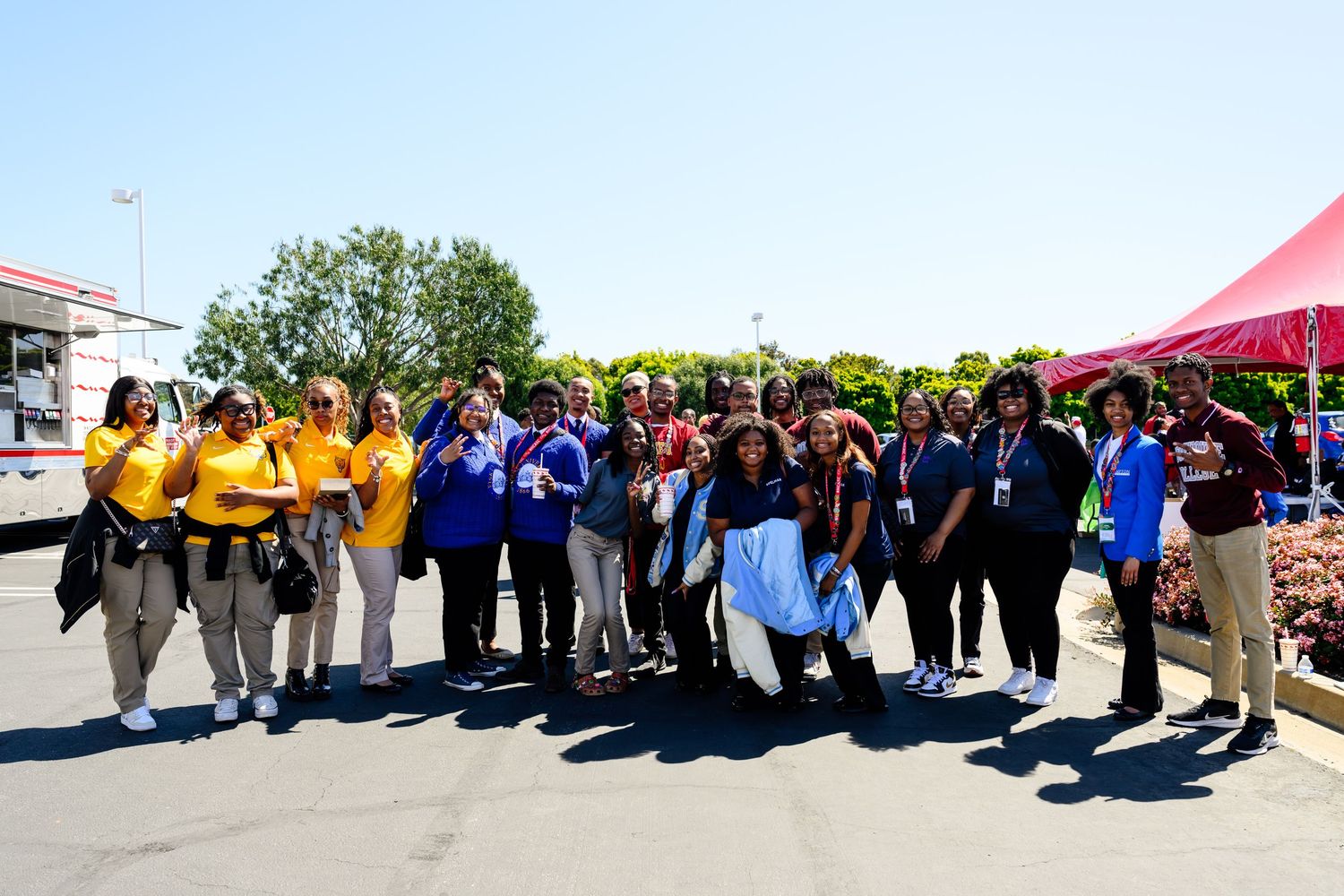 Large group of participants gathered outdoors for a group photo at an event.