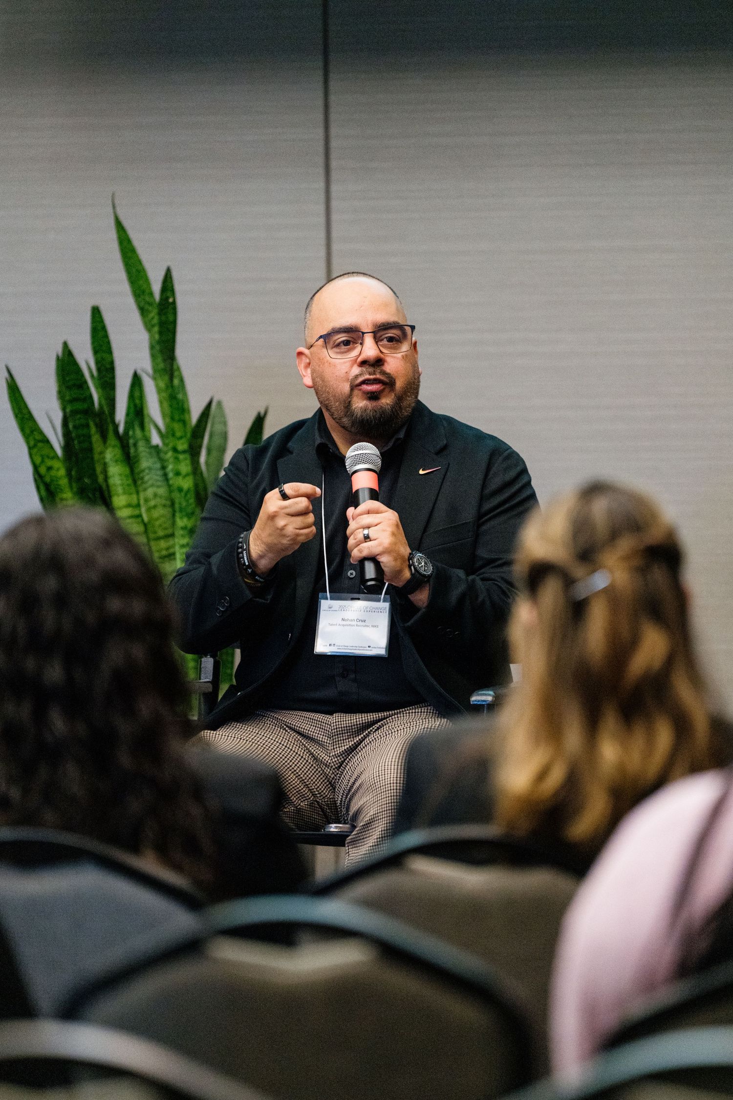 Speaker addressing an audience during a professional conference presentation.