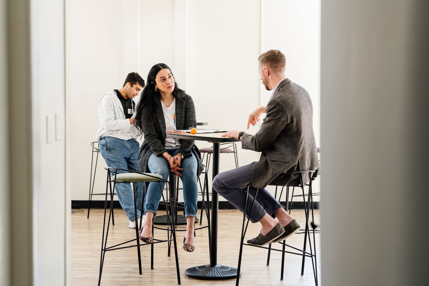 Small group having a casual business meeting at a high-top table.