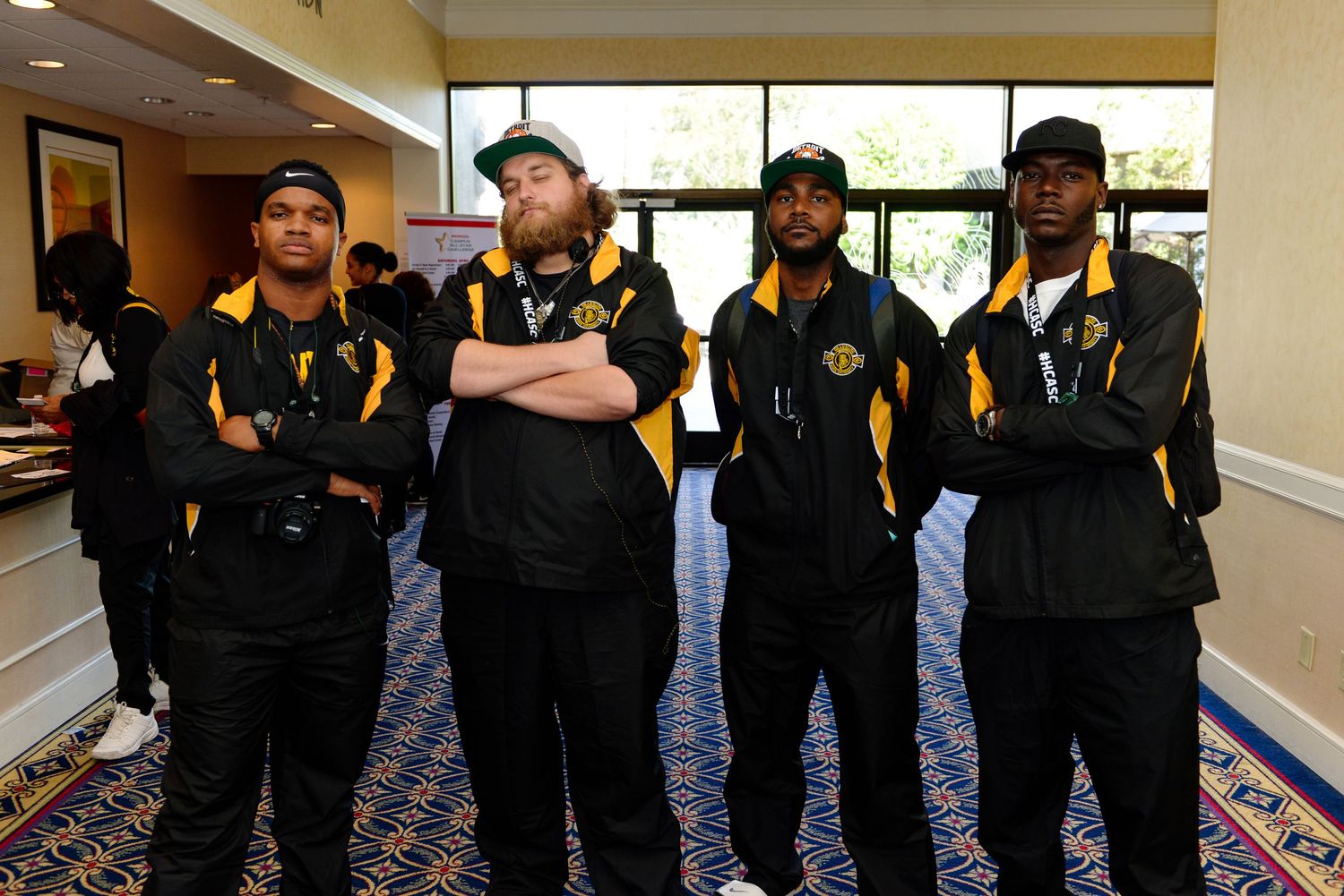 Team members in matching black and yellow uniforms standing in a hallway.