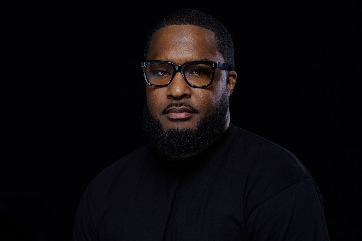 Low-key portraits showing a person in dark clothing against black background.