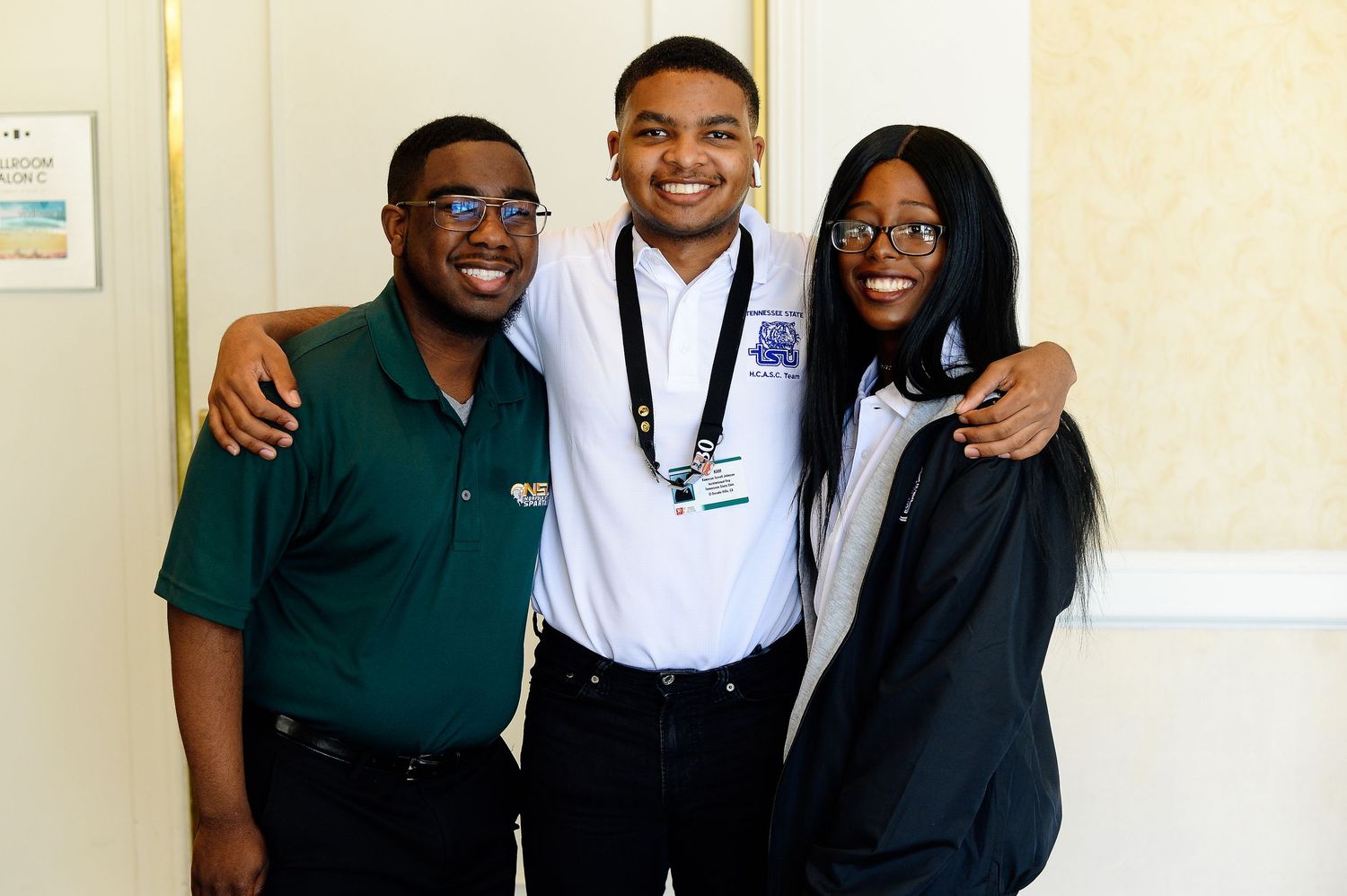 Students in professional attire pose together in a school or office setting.
