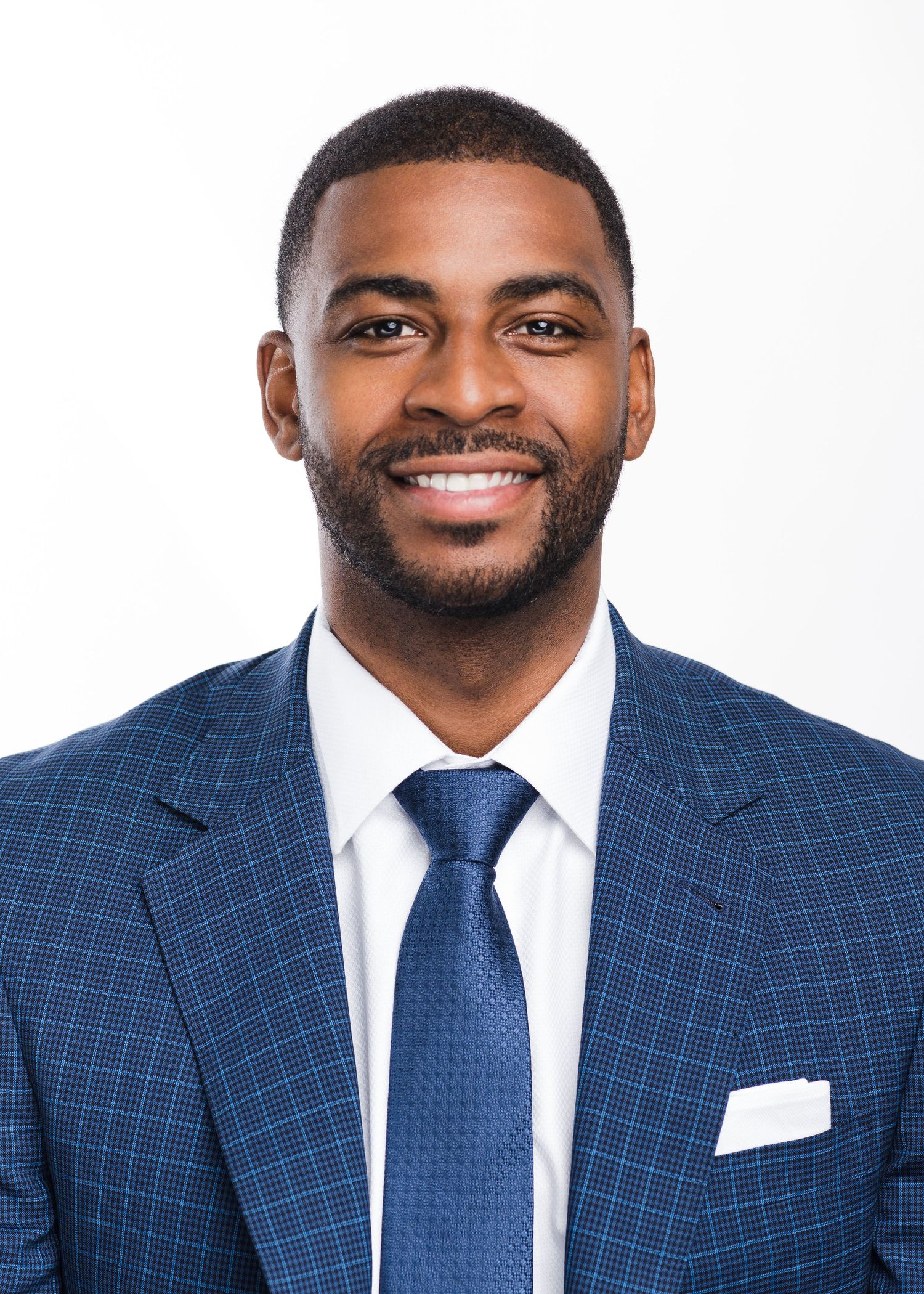 Professional headshots in navy checkered suit and tie against white background.