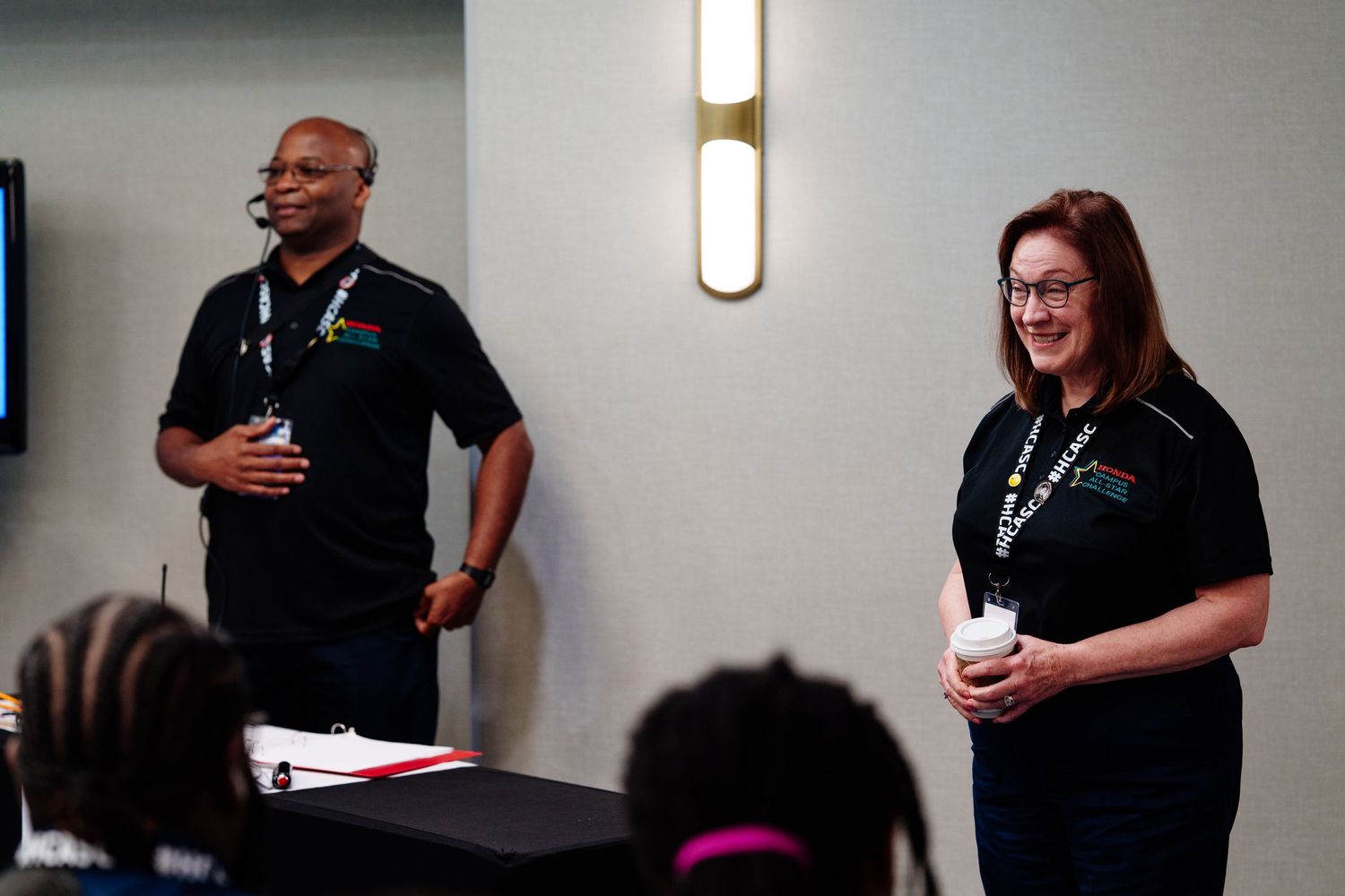 Two presenters leading a professional workshop or training session.