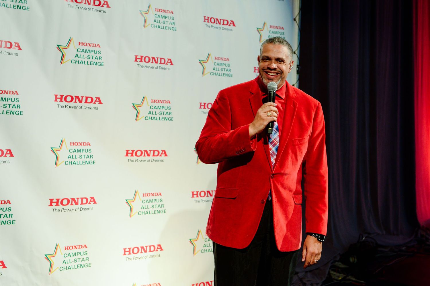 Event stage setup with Honda branding and red backdrop at an awards ceremony.