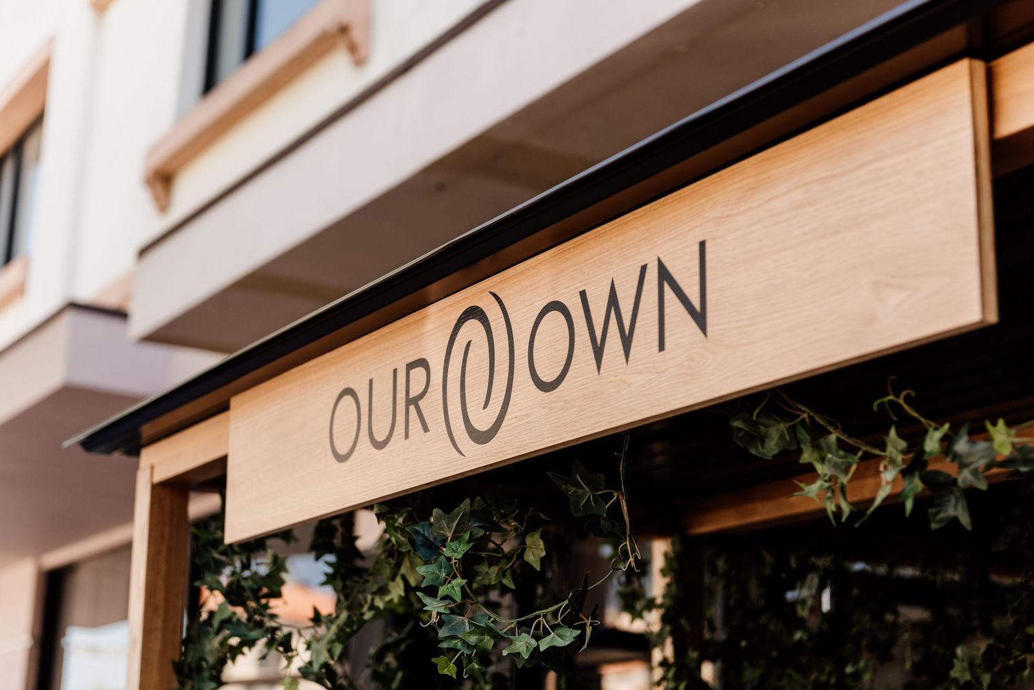 Modern storefront with white exterior and stylish signage.