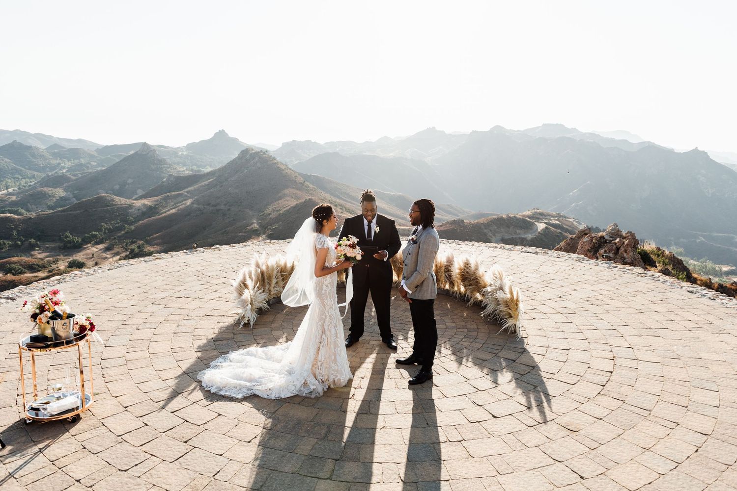 Mountain top wedding ceremony with scenic vista and stone platform.