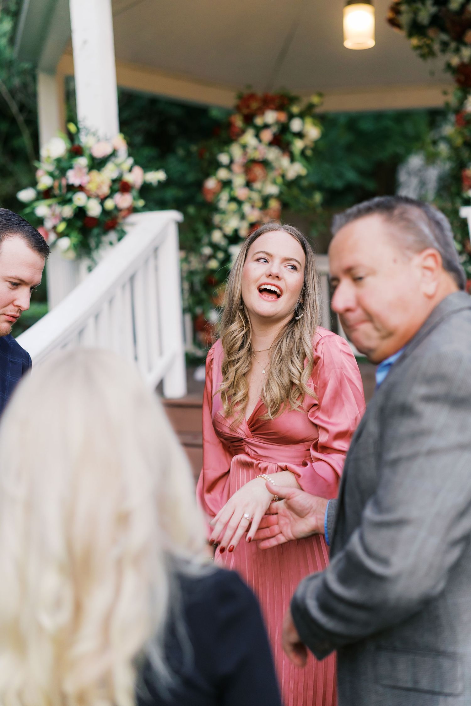 Candid laughter and happiness during a surprise engagement moment.