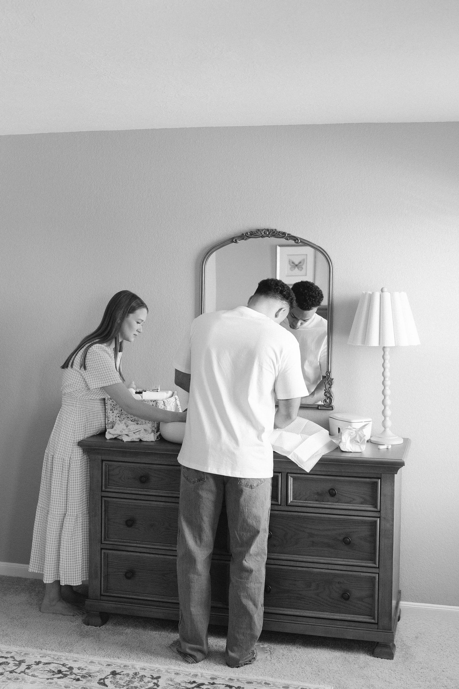 Black and white photo series showing a cat jumping onto a dresser.