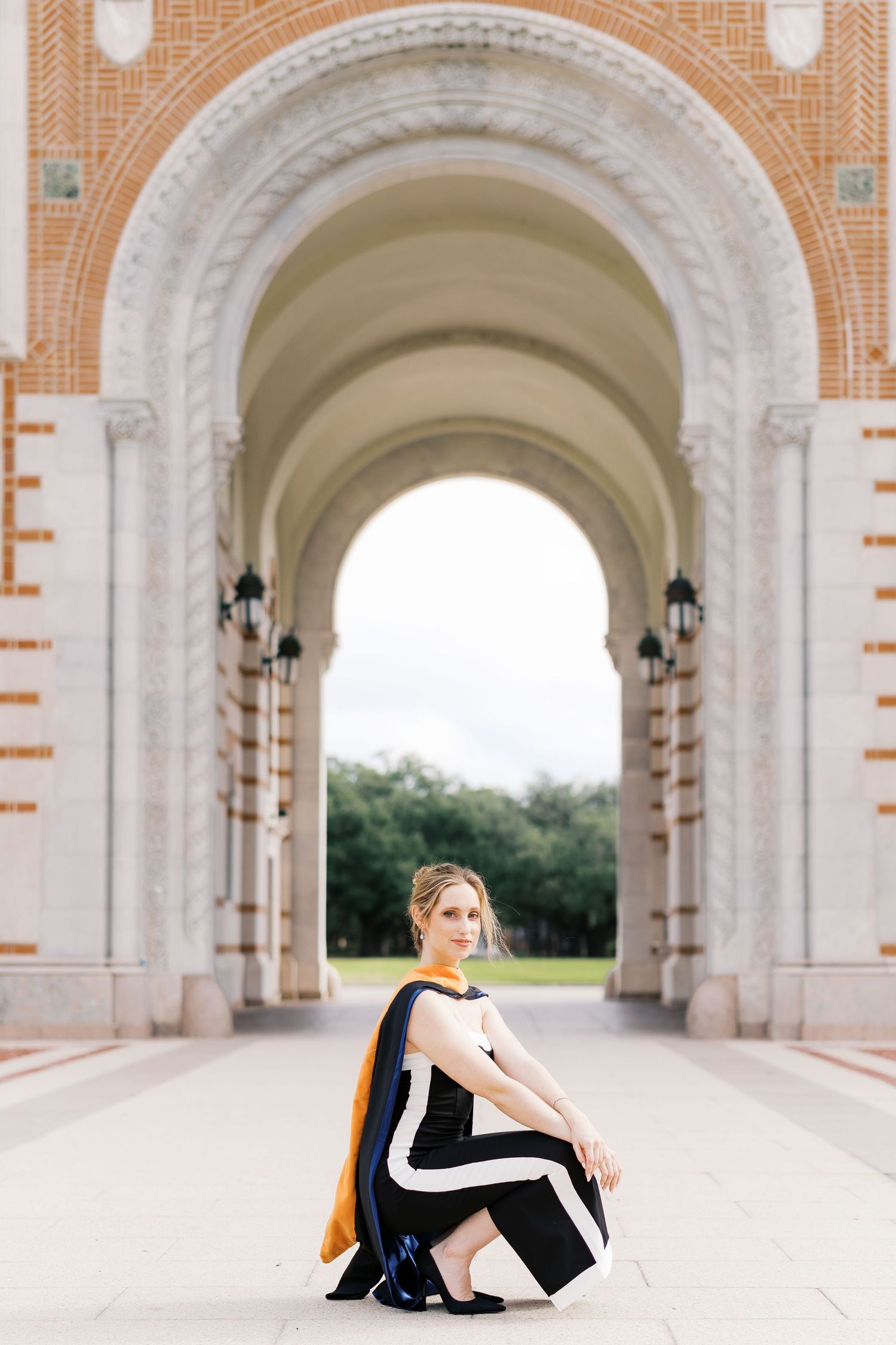 Artistic photo series in a classical arched corridor with black and white attire against stone architecture.