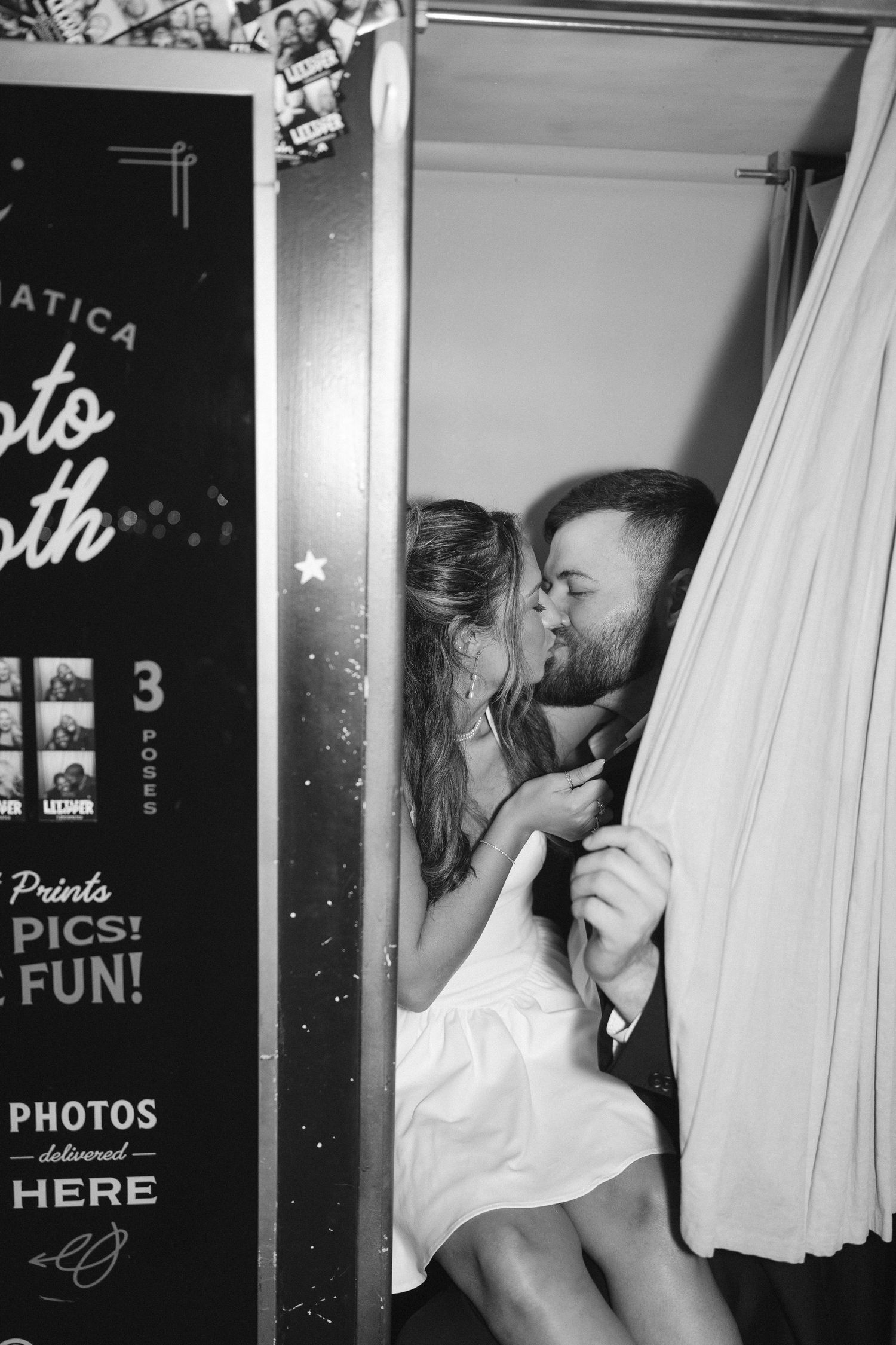 A series of black and white photos showing moments in a photo booth setting.